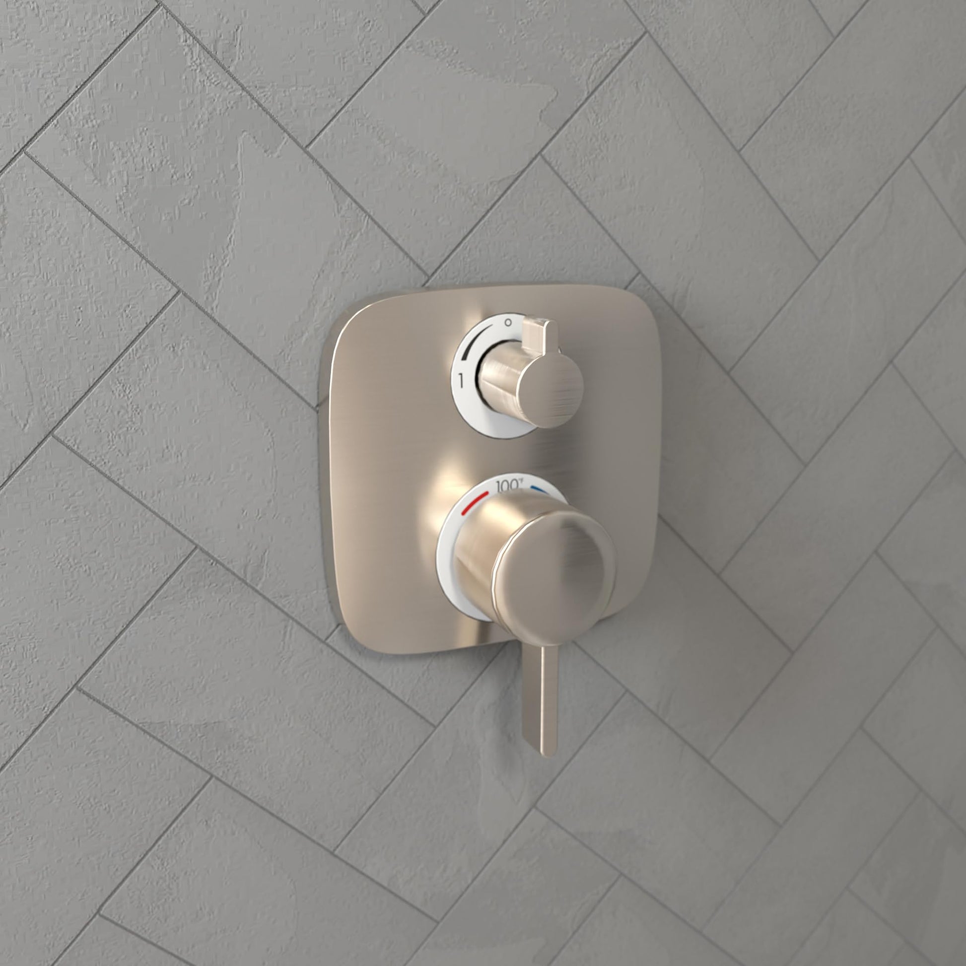 Brushed nickel thermostatic shower trim with dual controls mounted on herringbone tile wall.