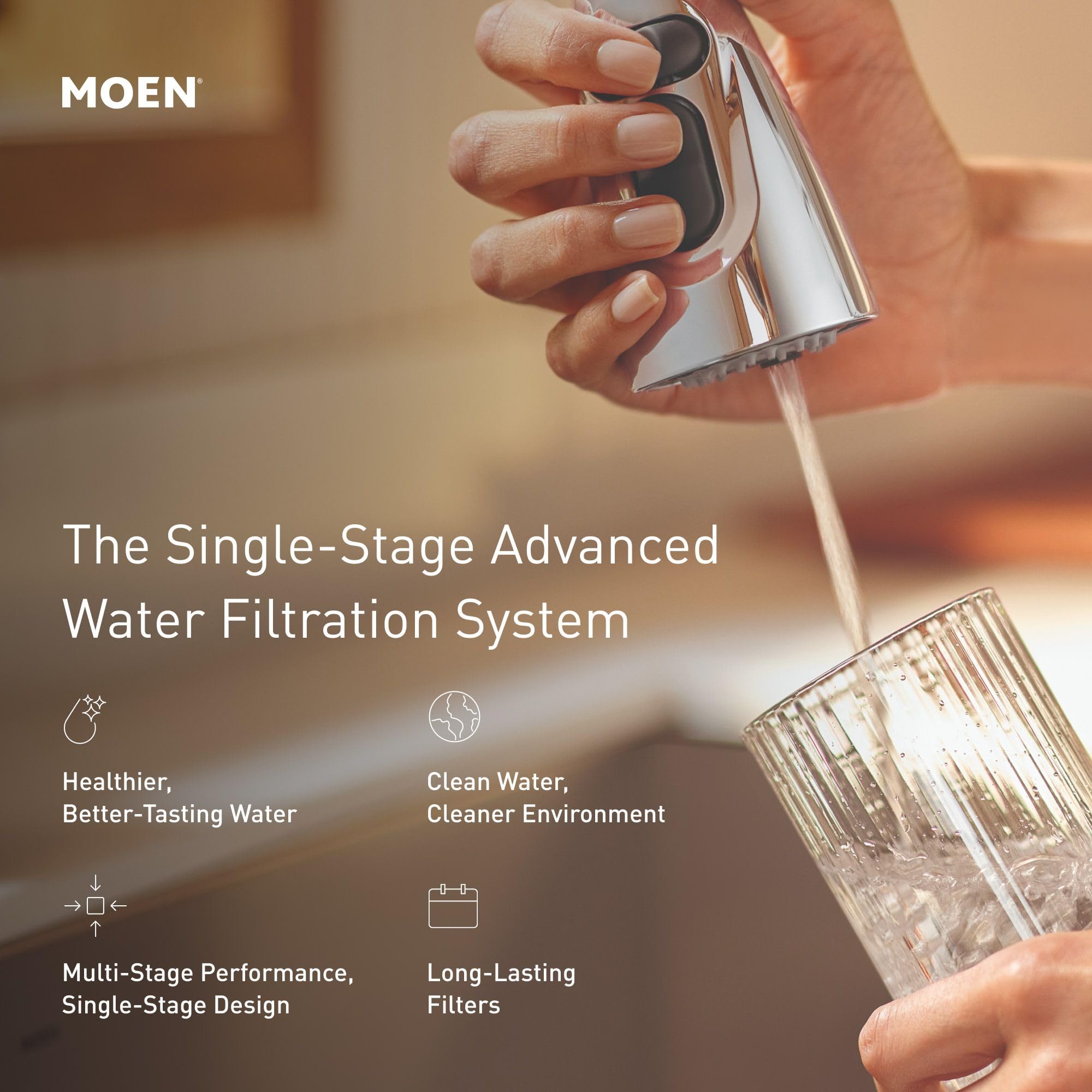 Chrome faucet with black grip being held while dispensing filtered water into a clear glass.