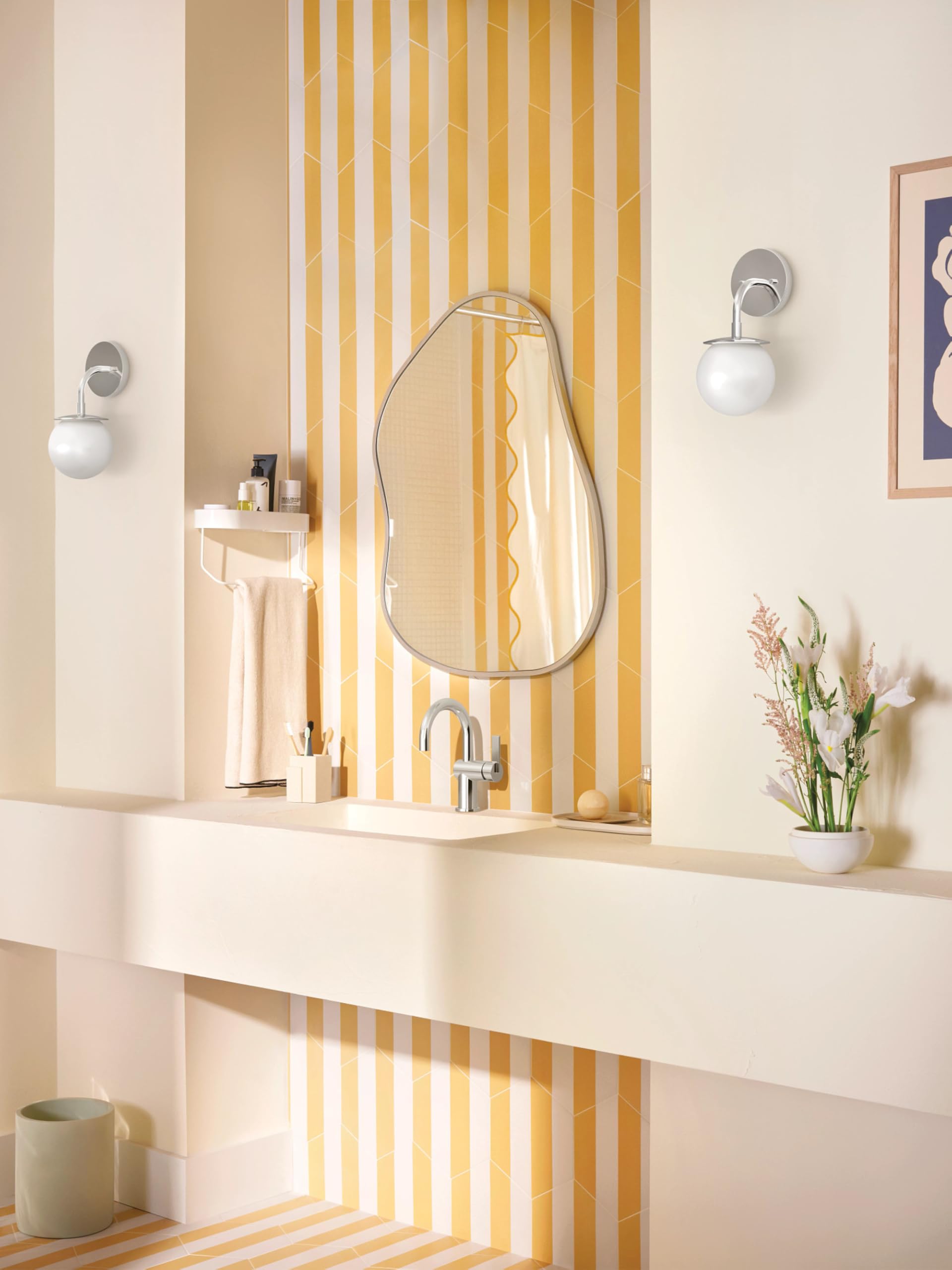 Chrome single-handle bathroom sink faucet with curved spout mounted on white vanity countertop.