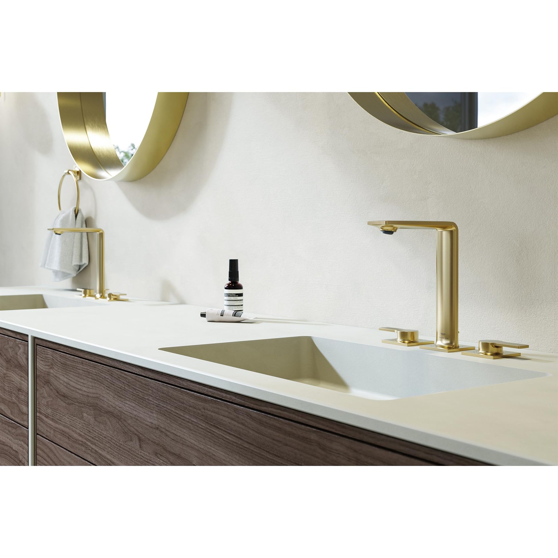Brushed nickel towel ring mounted on white bathroom wall above sink counter.