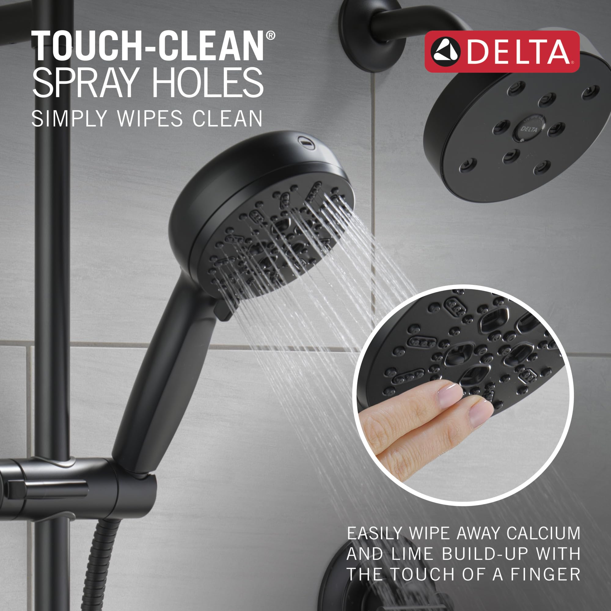 Matte black Delta hand shower with slide bar and cleaning spray holes, shown mounted on wall with water streaming.