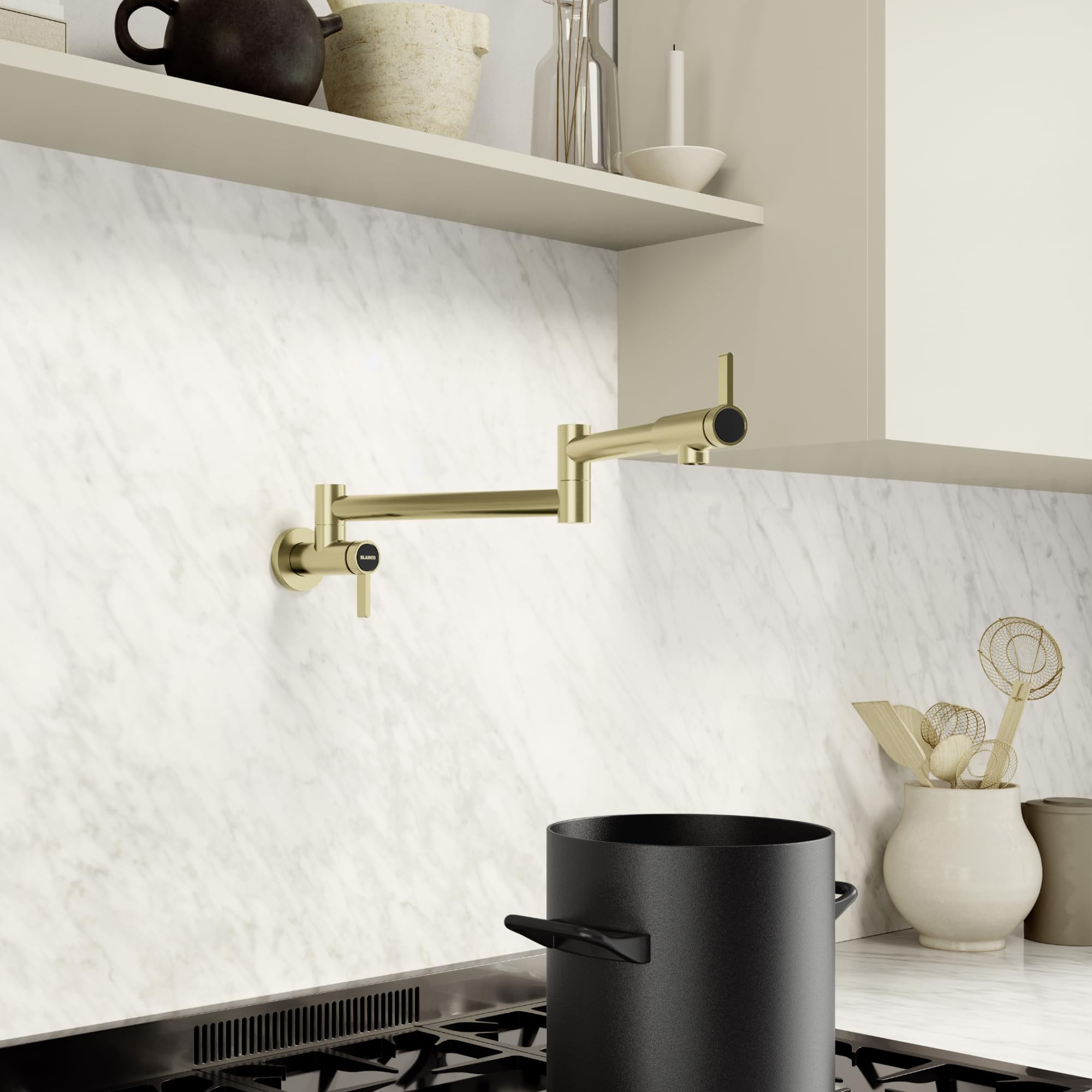 Satin gold wall-mounted potfiller faucet with articulating arm and single lever handle above stovetop.