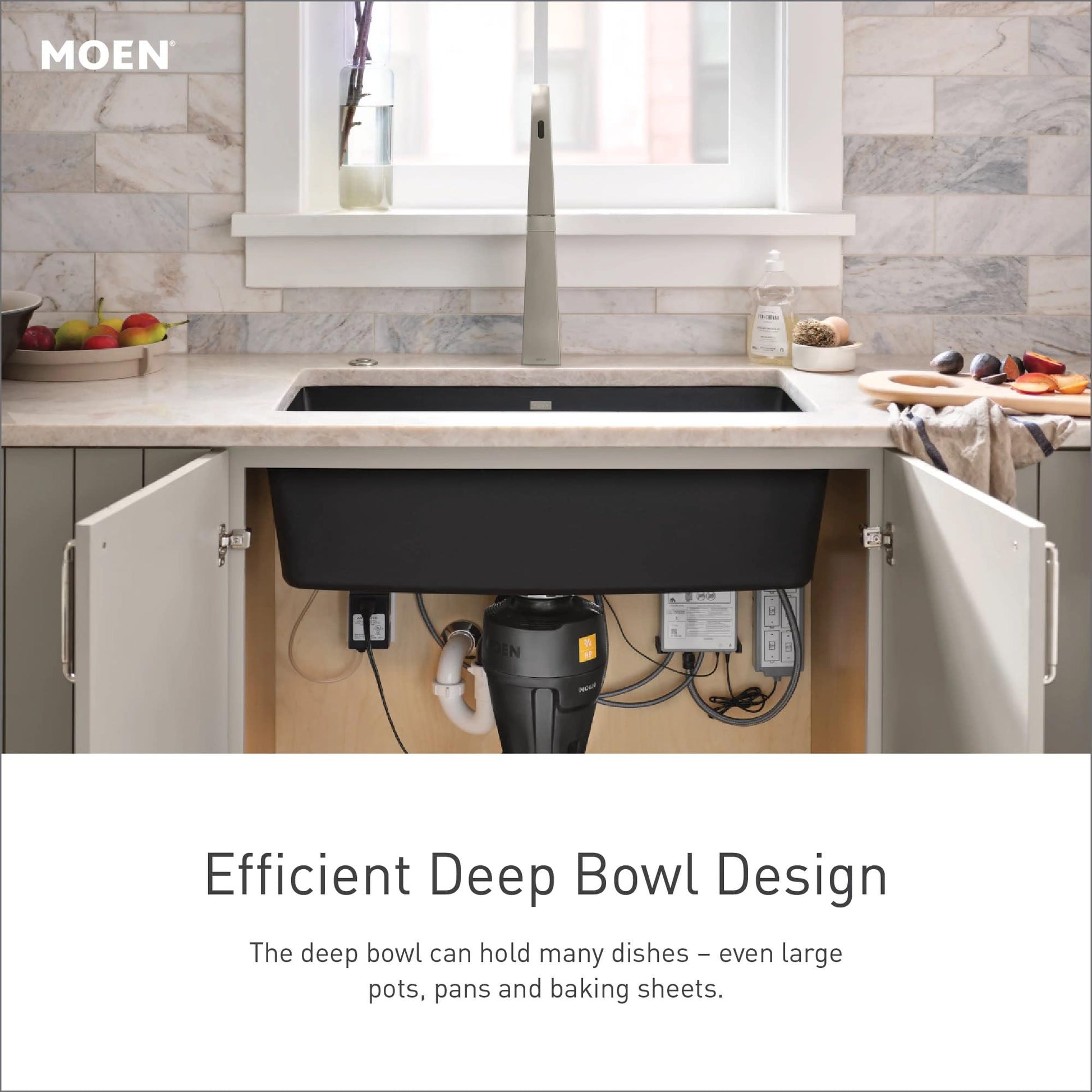 Matte black undermount single bowl kitchen sink installed under white countertop with gray cabinetry below.