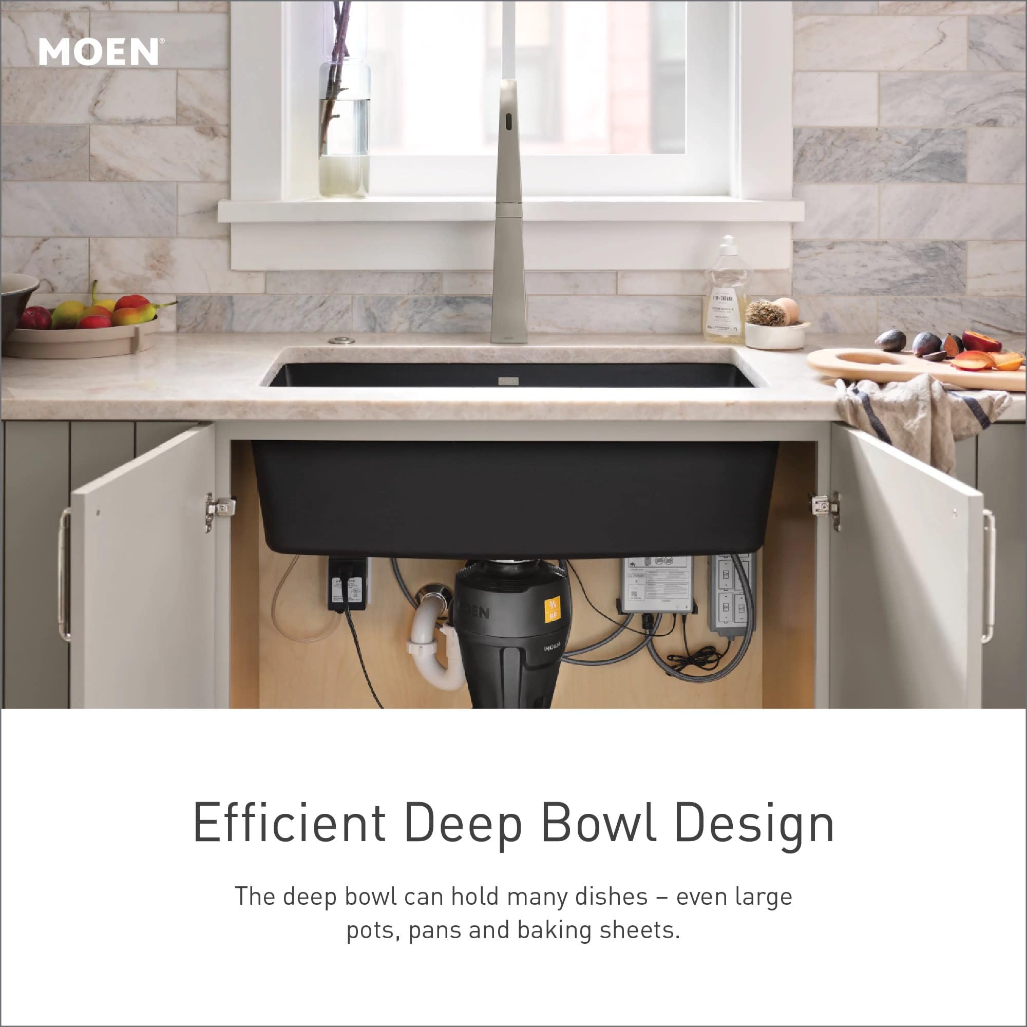Matte black undermount single bowl kitchen sink installed under white countertop with gray cabinetry below.