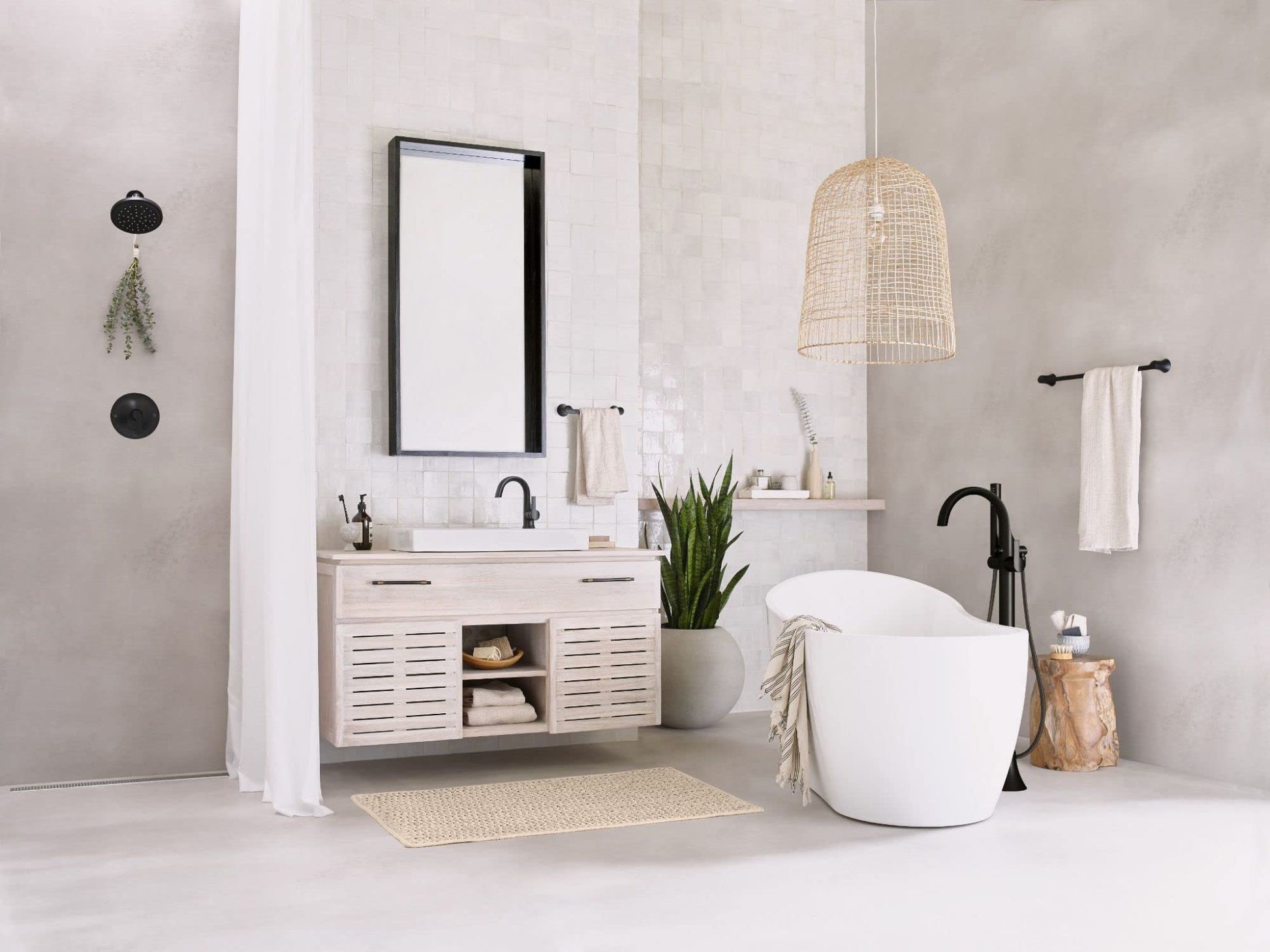 Matte black single-handle bathroom faucet with high arc spout mounted on white sink vanity in modern bathroom setting.
