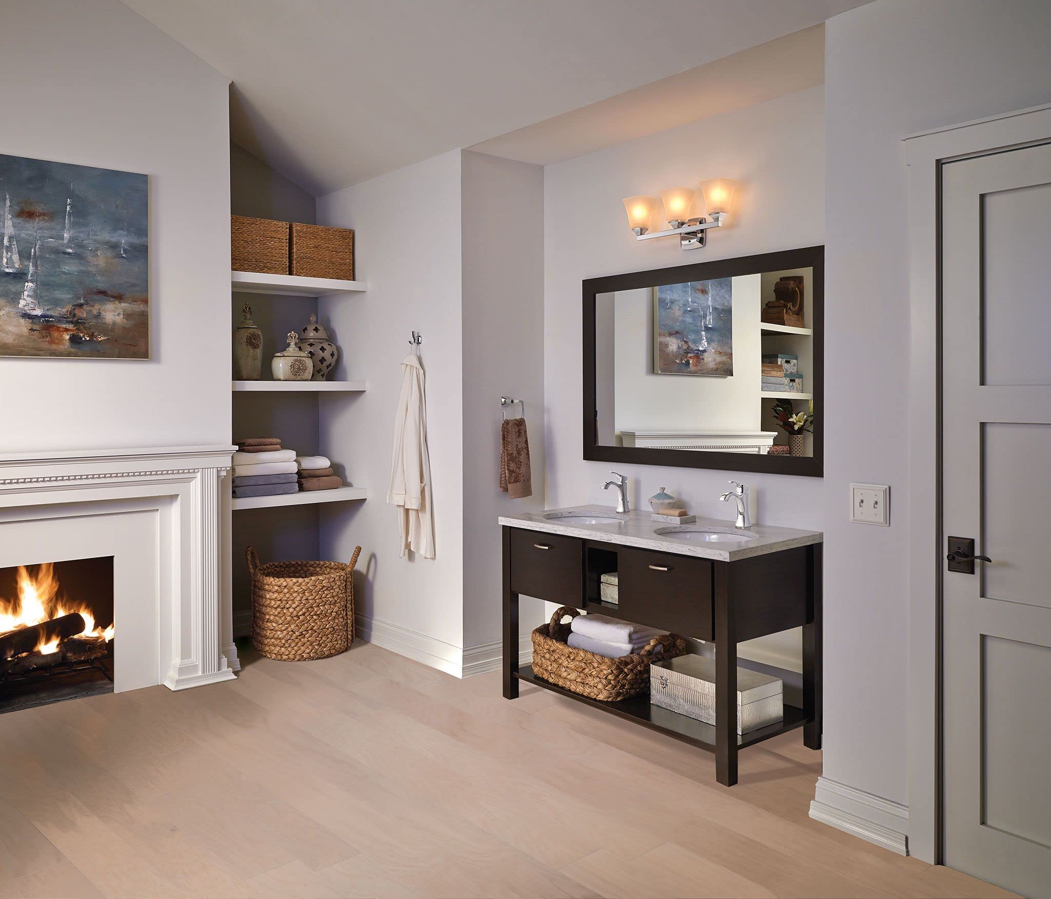 Chrome towel ring mounted on white wall beside bathroom vanity sink.