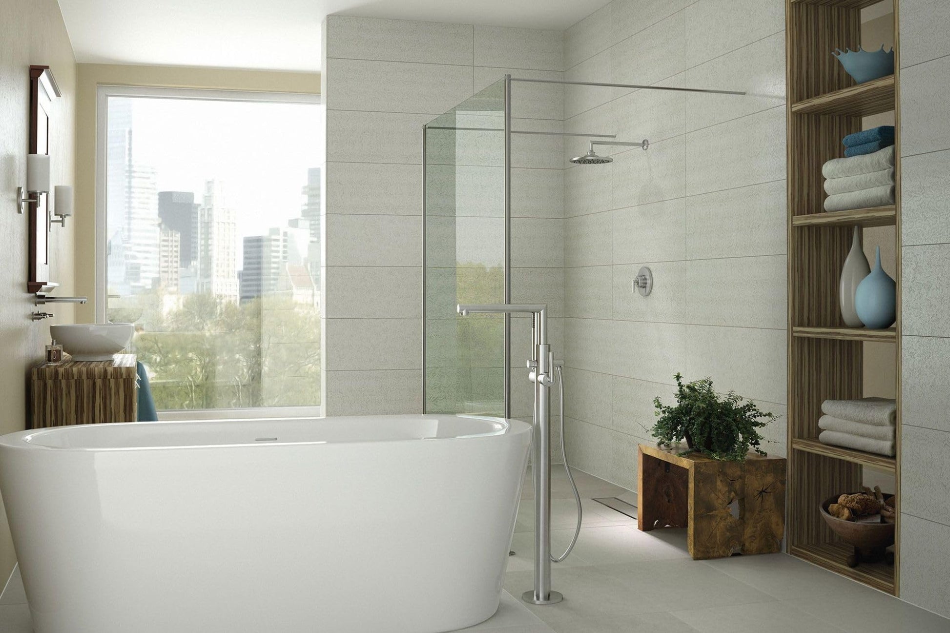 Floor-mount tub filler valve with chrome finish shown installed next to freestanding soaking tub in modern bathroom.