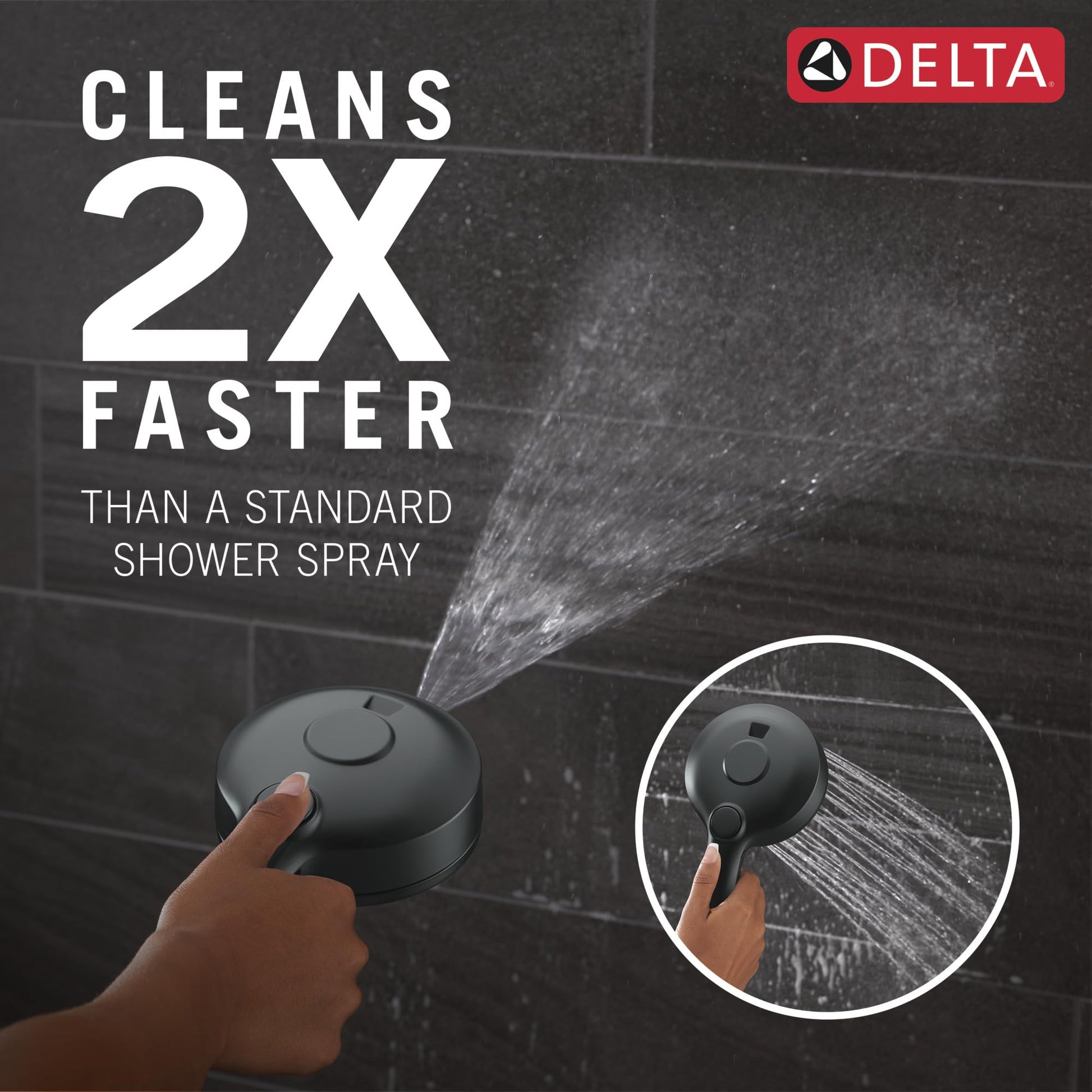 Matte black Delta showerhead with control button held in hand, spraying water against dark tile background.