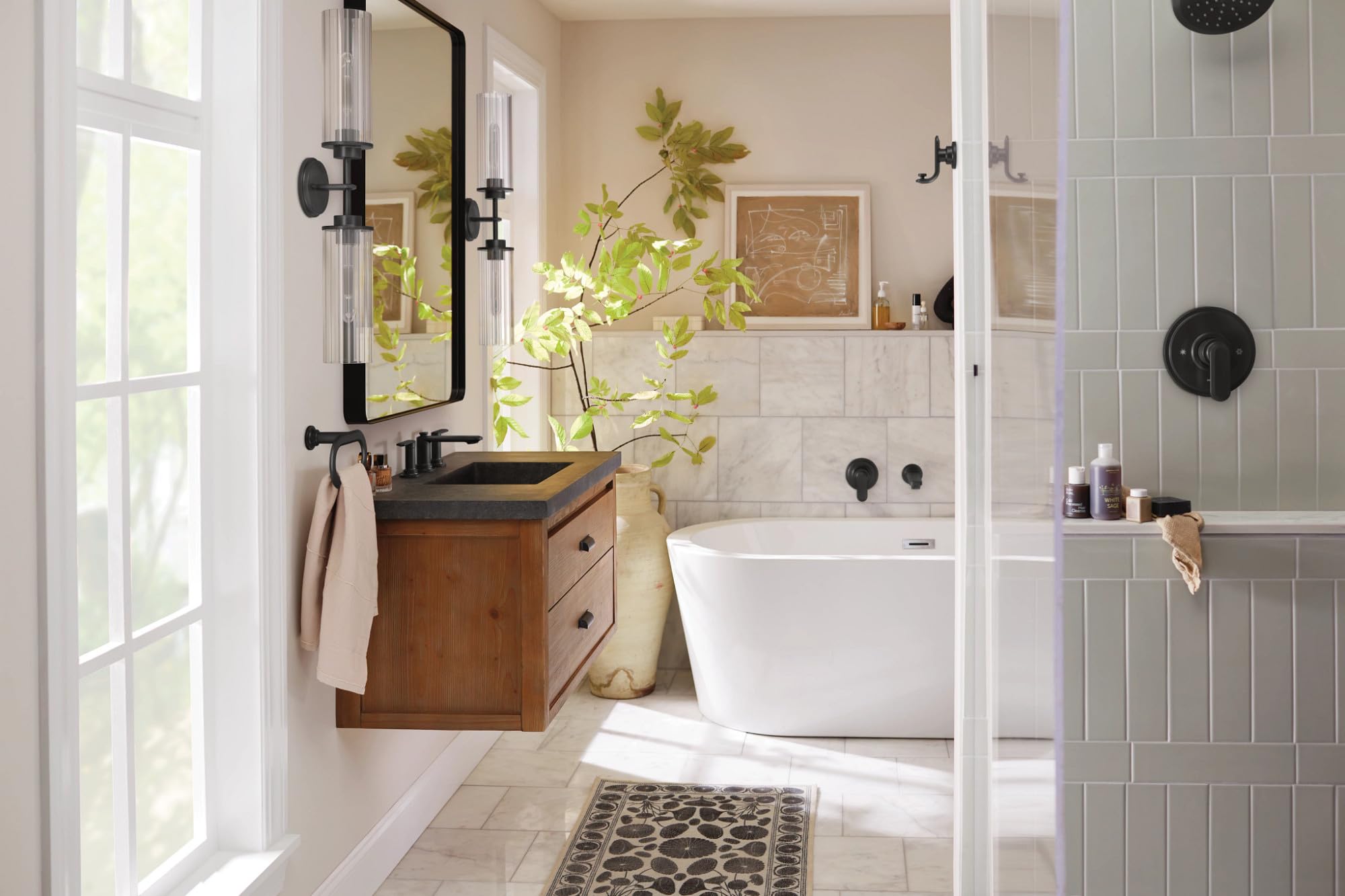 Matte black wall-mounted tub filler with single lever handle installed above white soaking tub in bathroom.