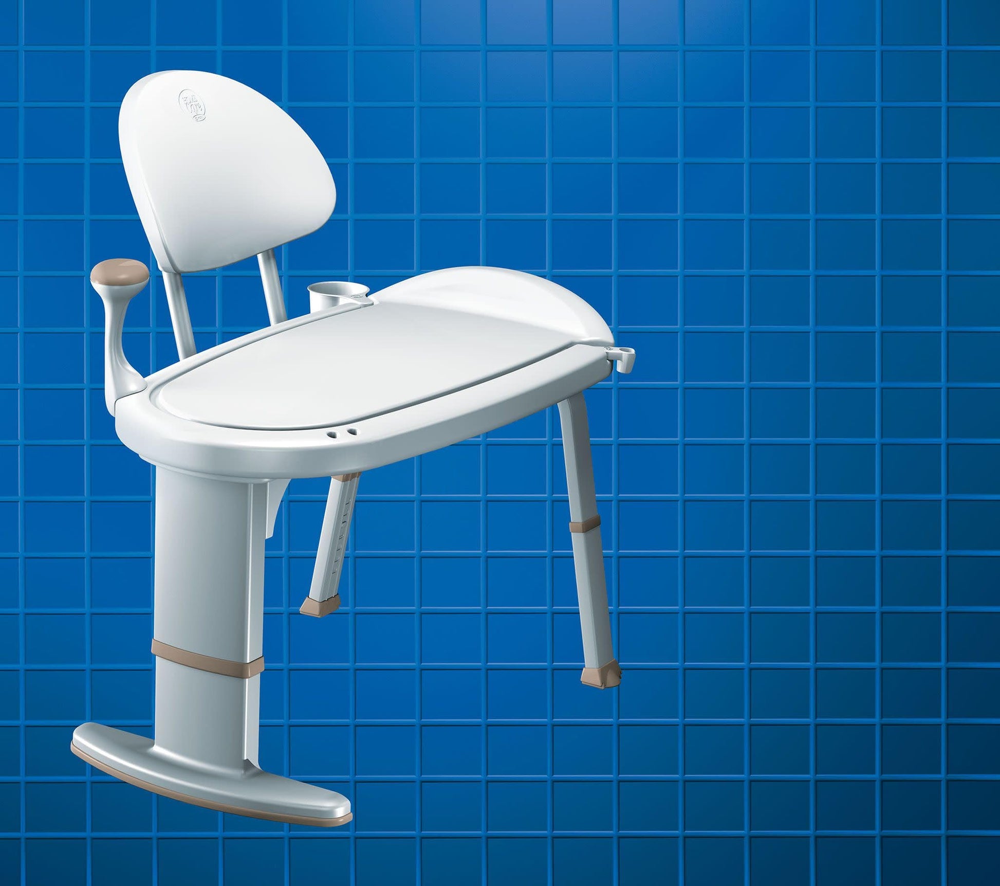 White bath transfer bench with padded seat, backrest, and armrests on four legs against blue tiled background.