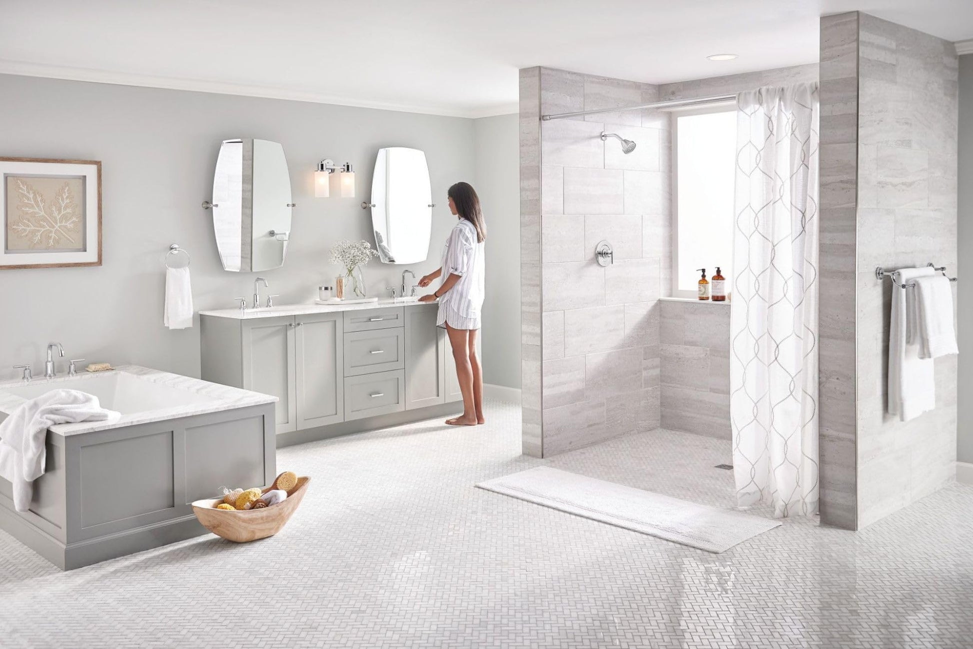 Chrome single-handle shower trim kit installed in bathroom shower enclosure with glass door and white tile surround.