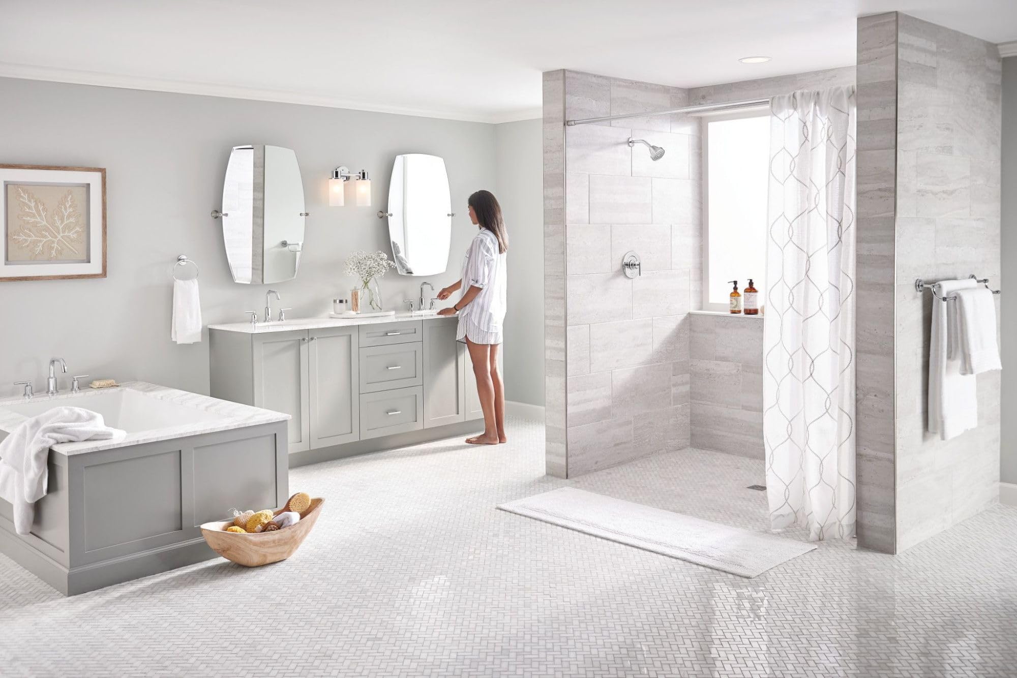 Chrome single-handle shower trim kit installed in bathroom shower enclosure with glass door and white tile surround.