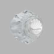 Clear acrylic hexagonal knob handle with Delta branding and decorative swirl pattern on face.
