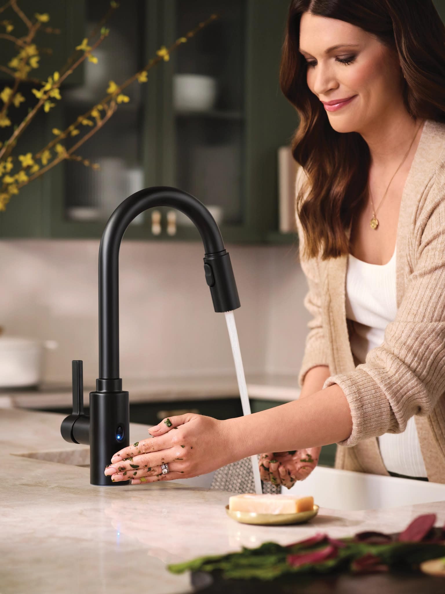 Matte black high-arc pulldown kitchen faucet with single handle and motion sensor activation.