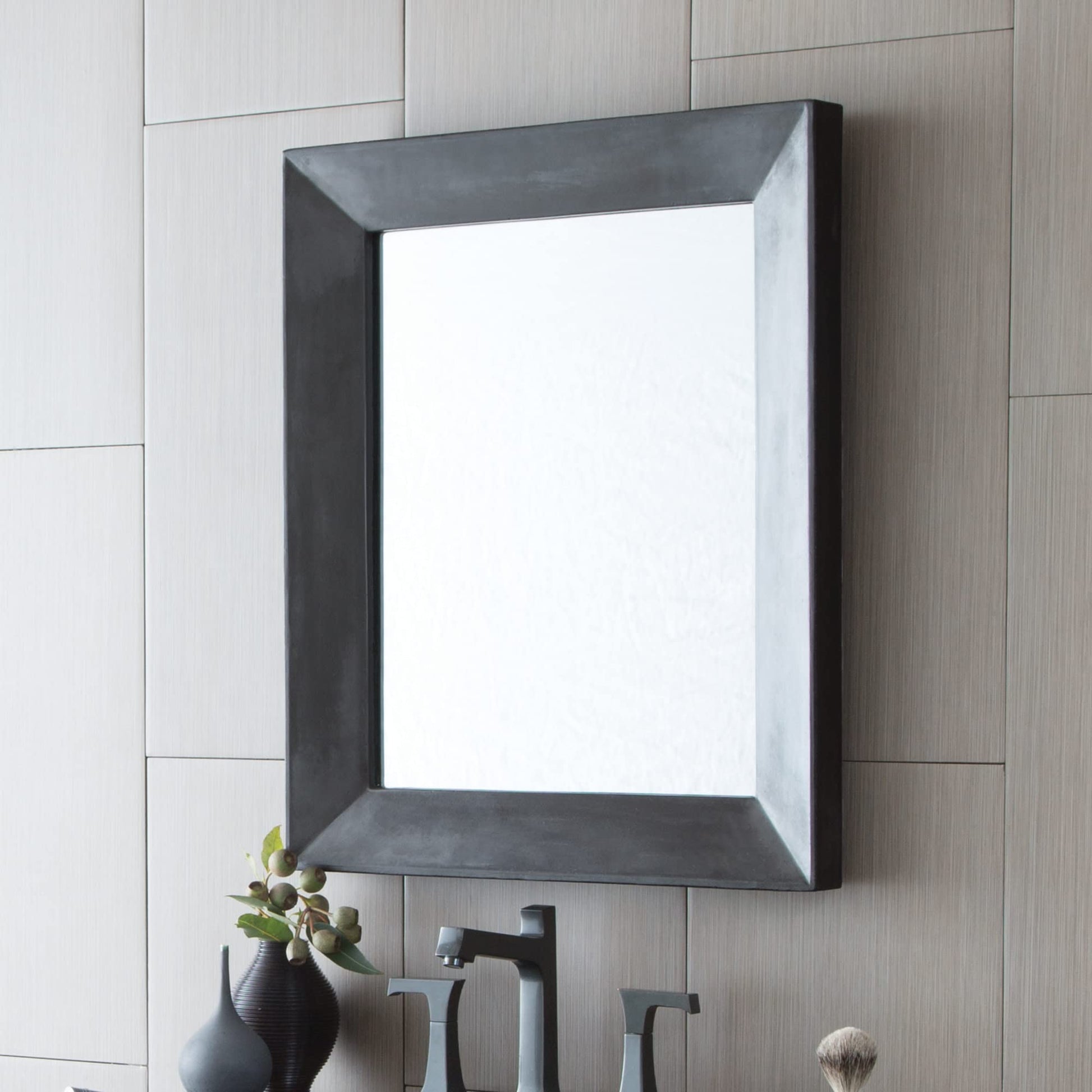 Rectangular wall mirror with dark gray concrete-textured frame and beveled edges mounted above bathroom vanity.
