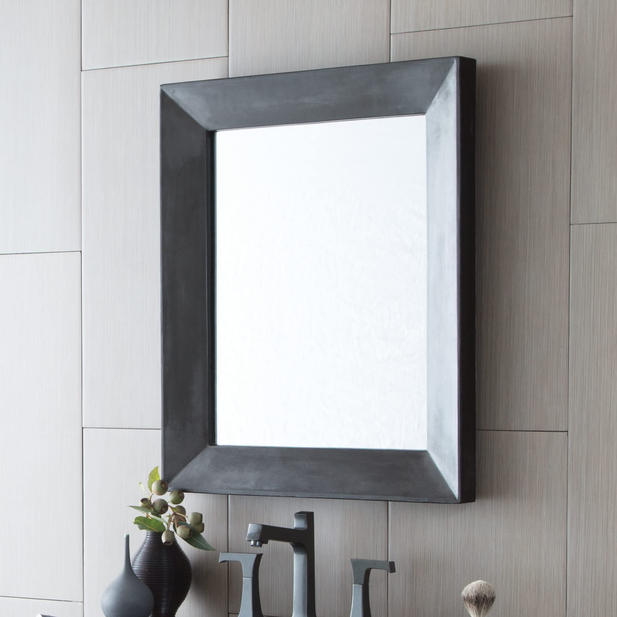 Rectangular wall mirror with dark gray concrete-textured frame and beveled edges mounted above bathroom vanity.