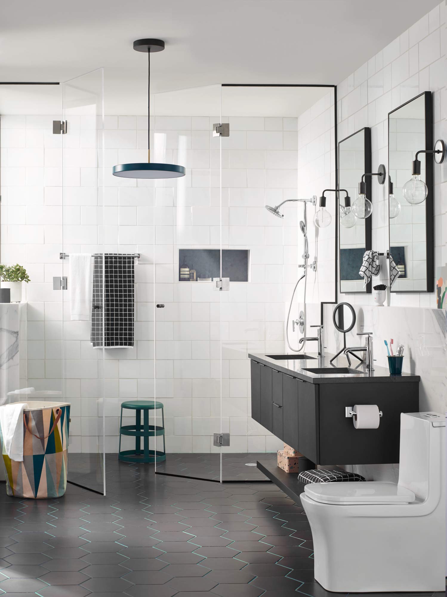 Chrome double towel bar mounted horizontally on bathroom wall above black vanity sink.