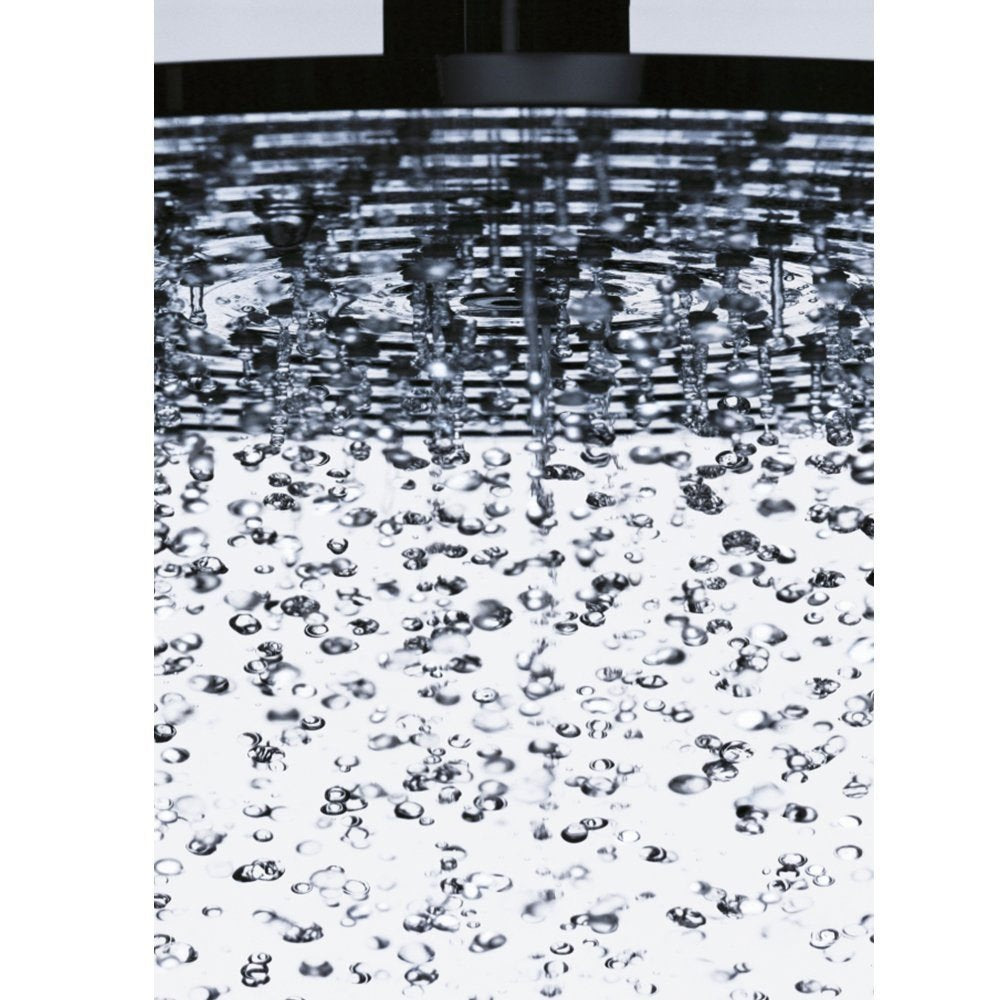 Chrome shower head with multiple water jets spraying downward onto a white surface.
