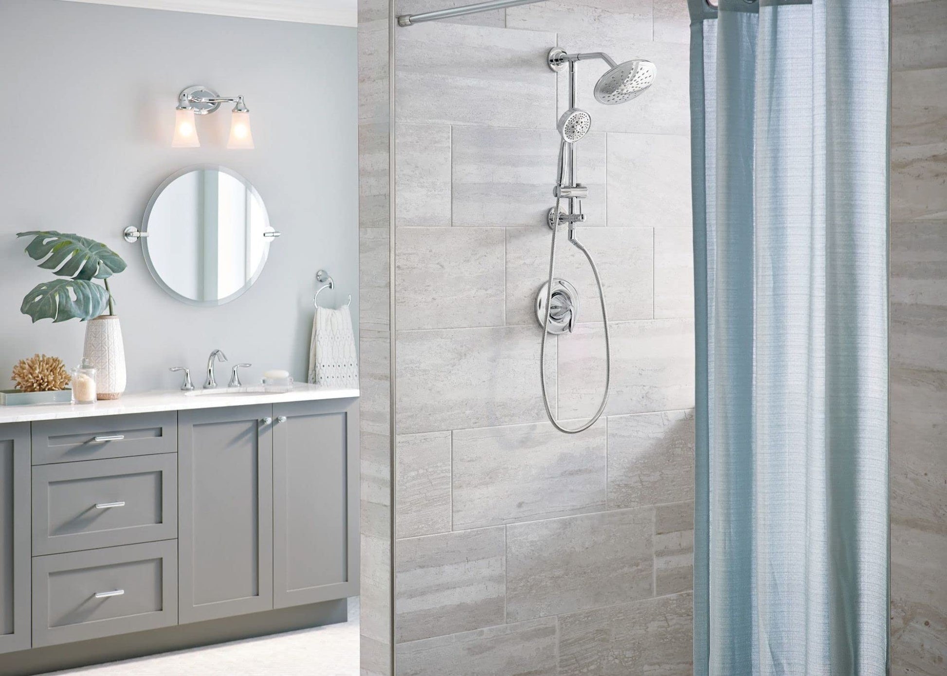 Chrome wall-mount towel ring installed on bathroom tile wall next to shower enclosure.
