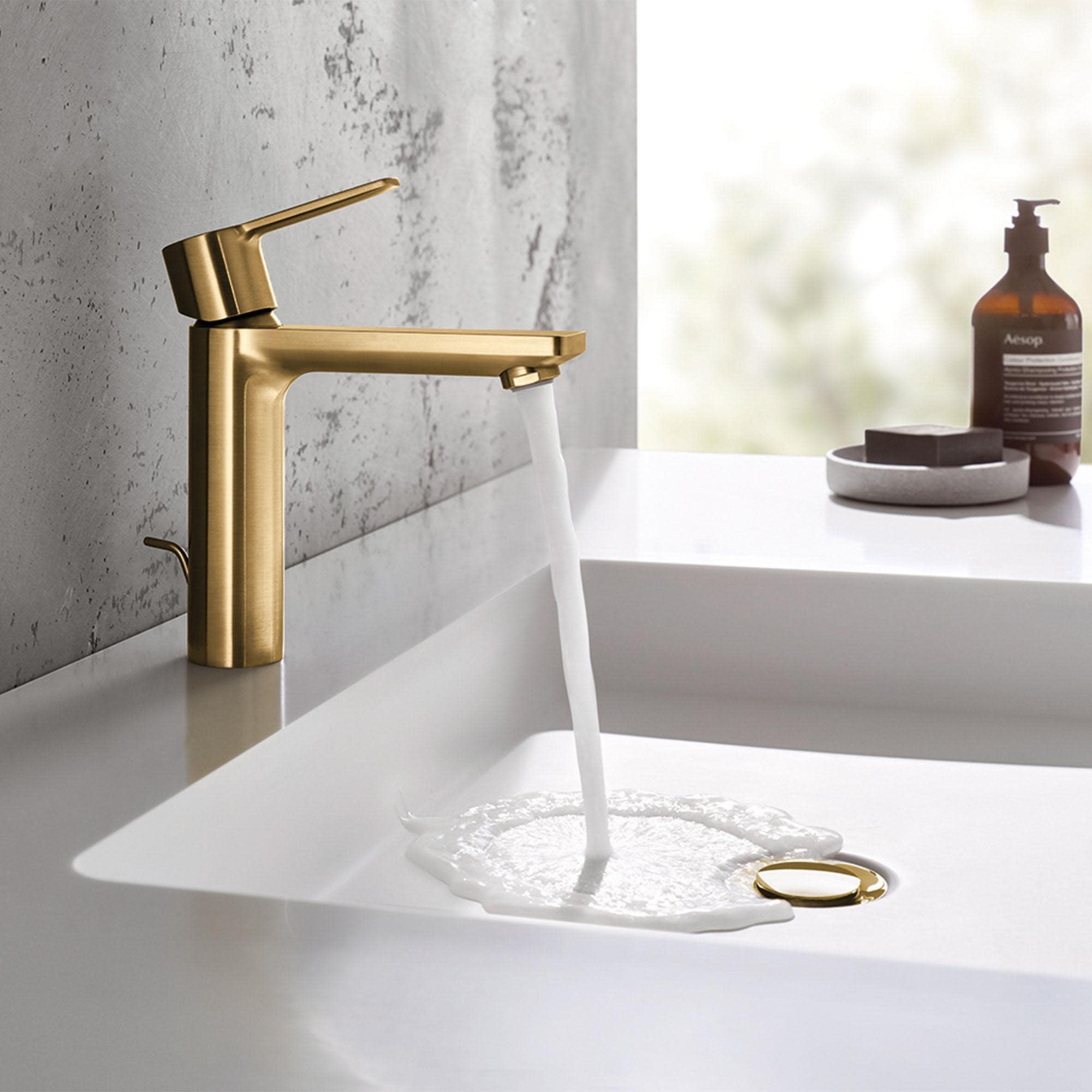 Matte black single-handle bathroom faucet with angled spout dispensing water into white sink basin.