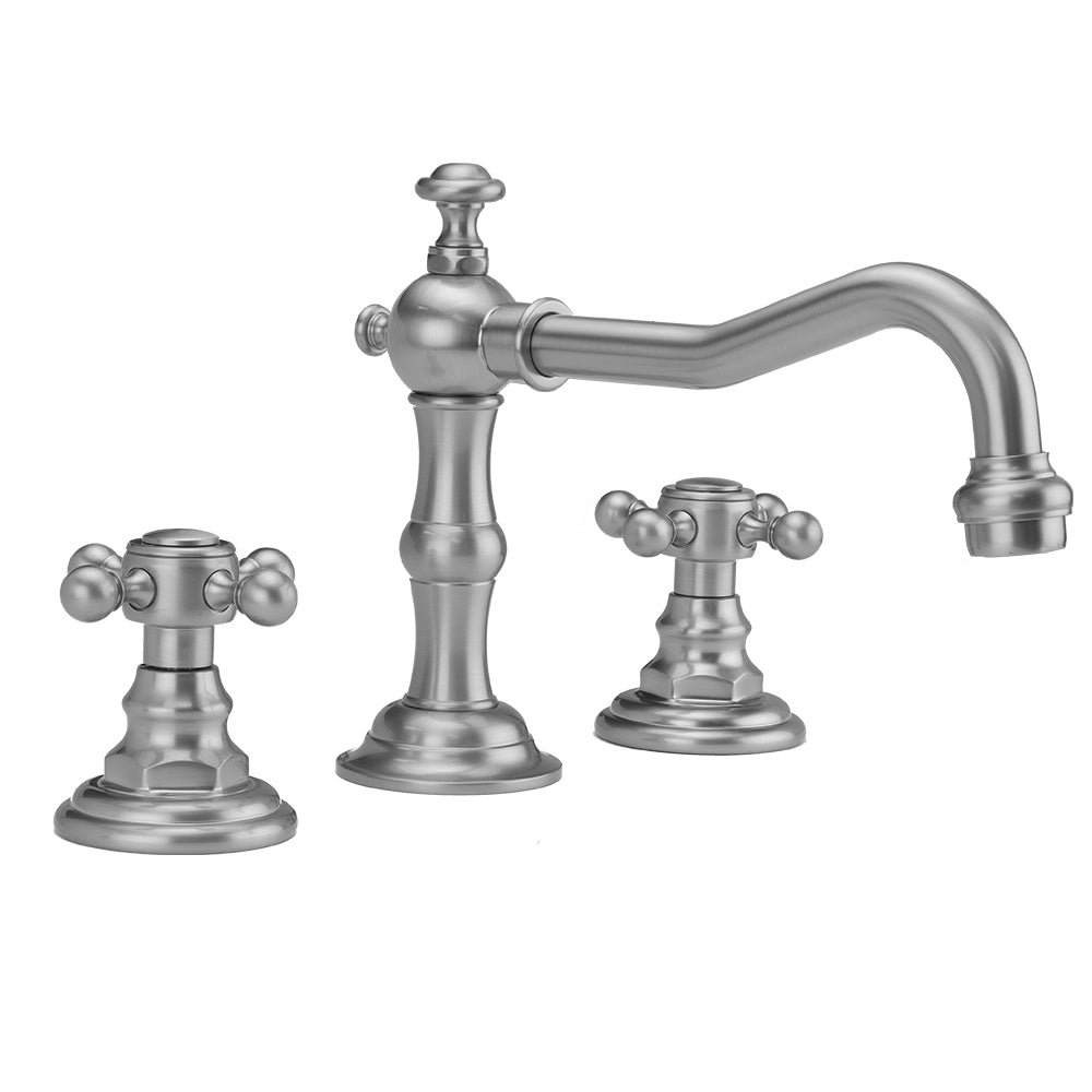 Polished chrome three-piece faucet with curved spout and ball cross handles on round bases.