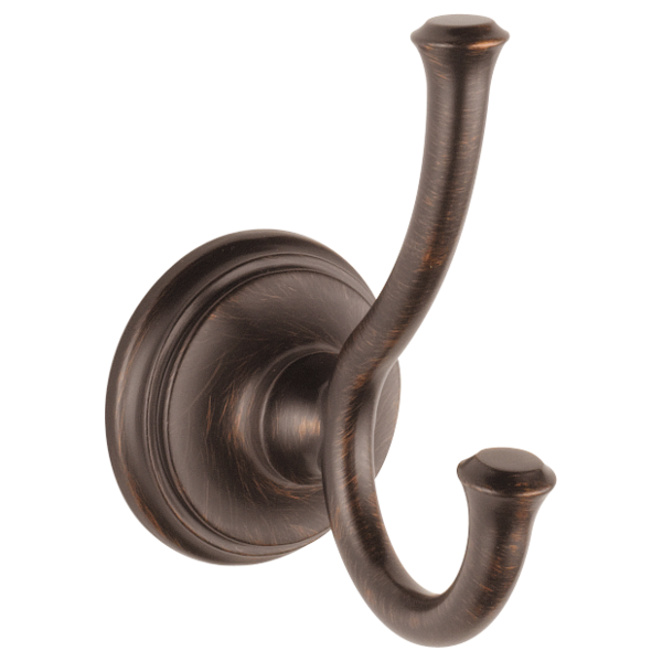Oil-rubbed bronze double robe hook with curved hooks mounted on circular wall plate.