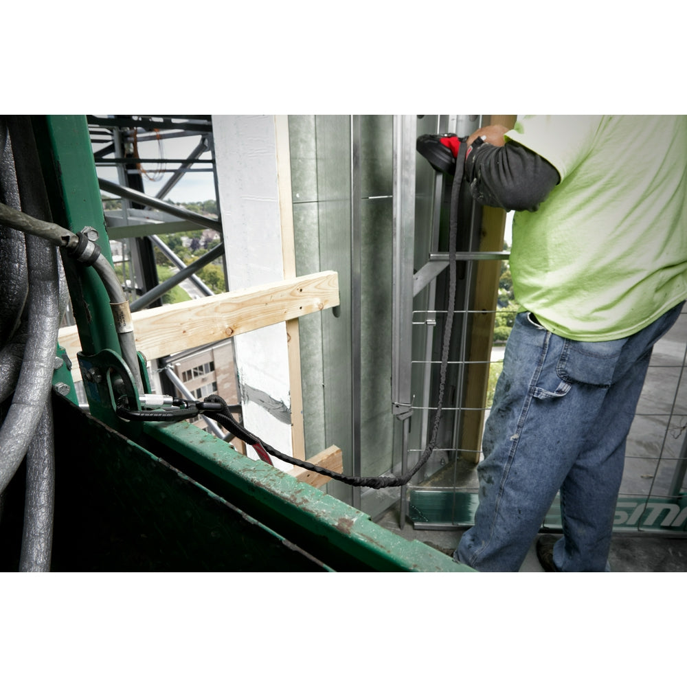 Black tool lanyard with carabiner attached to worker's belt on construction site.