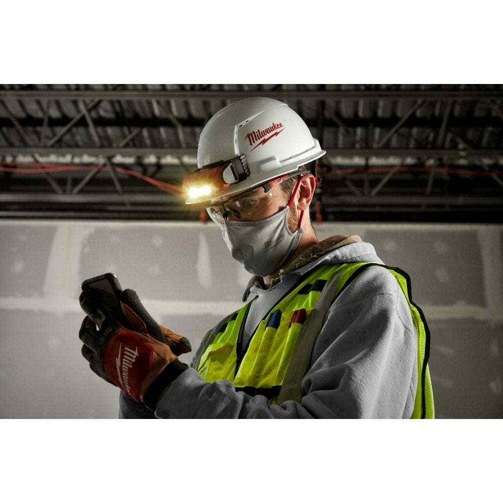 Clear safety glasses with anti-scratch lenses worn by worker on industrial job site.
