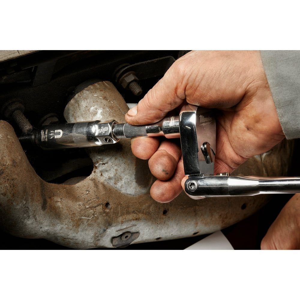 Magnetic spark plug socket being used to remove a spark plug from an engine with a ratchet wrench.