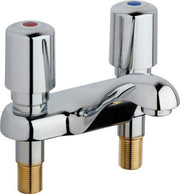 Chrome deck-mounted faucet with two metering handles, curved spout, and brass inlet connectors.