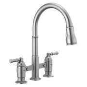Chrome bridge kitchen faucet with high curved spout, pull-down spray head, and two lever handles.