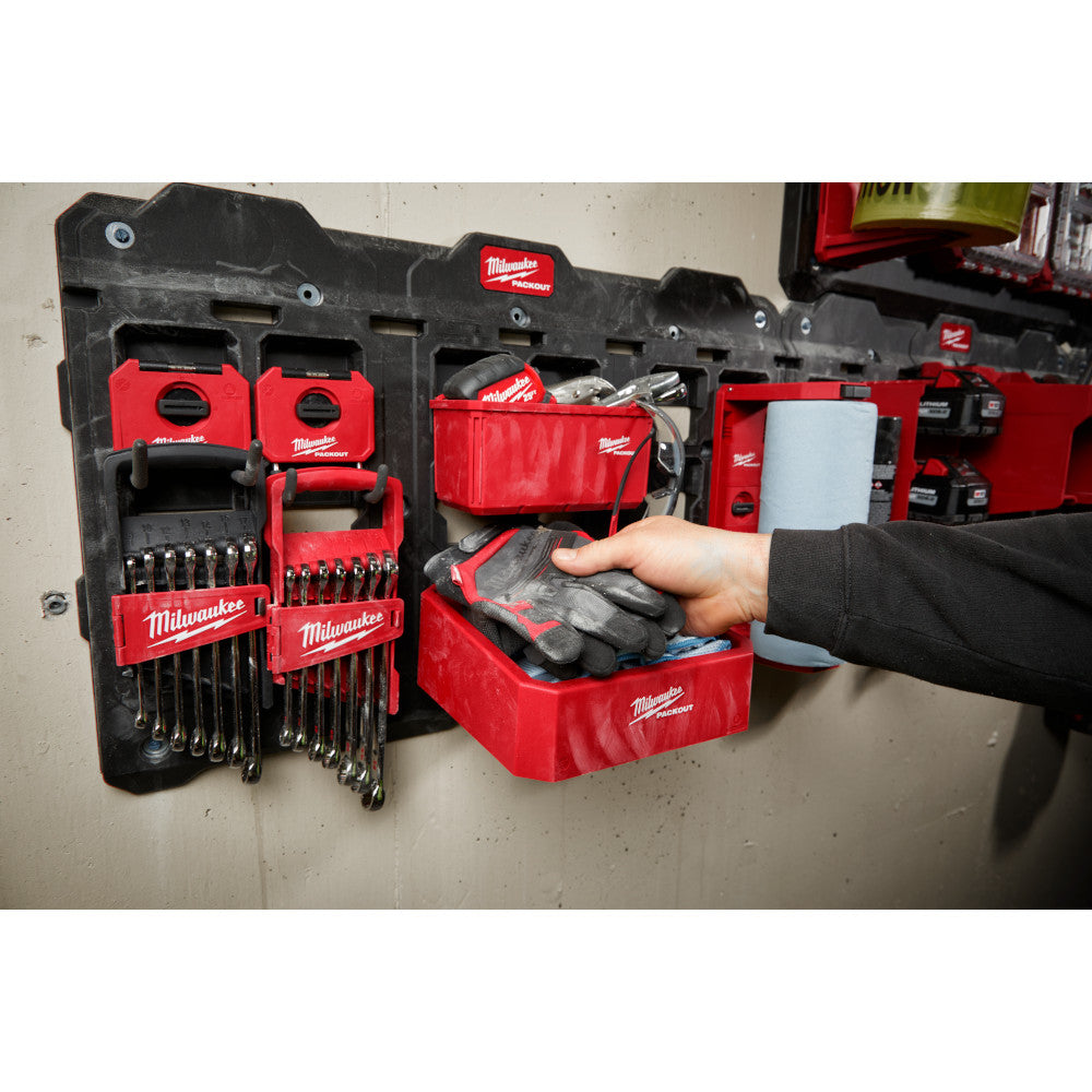 Red and black Milwaukee PACKOUT compact shelf unit mounted on wall with storage compartments and tool organizers.