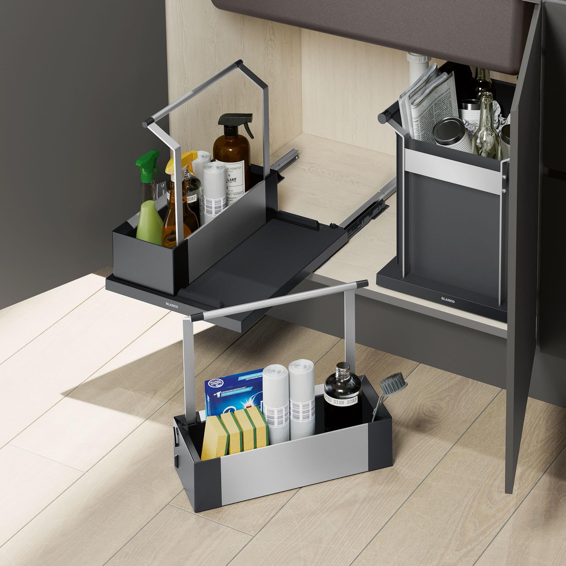 Black double-tier storage caddy with compartments holding cleaning supplies, sponges, and household items on kitchen counter.
