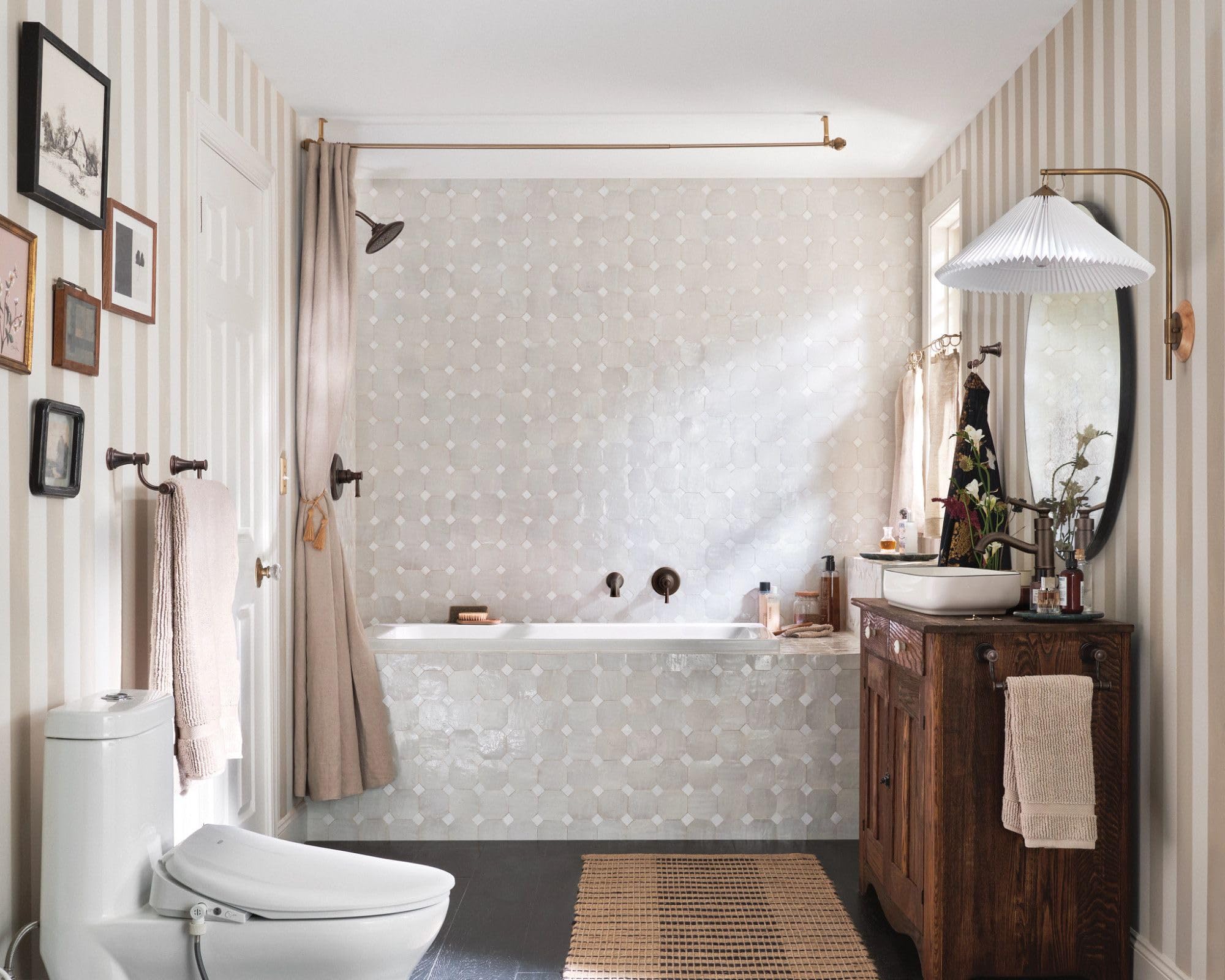 Oil rubbed bronze single-handle tub and shower trim kit installed above bathtub with matching fixtures visible in bathroom.