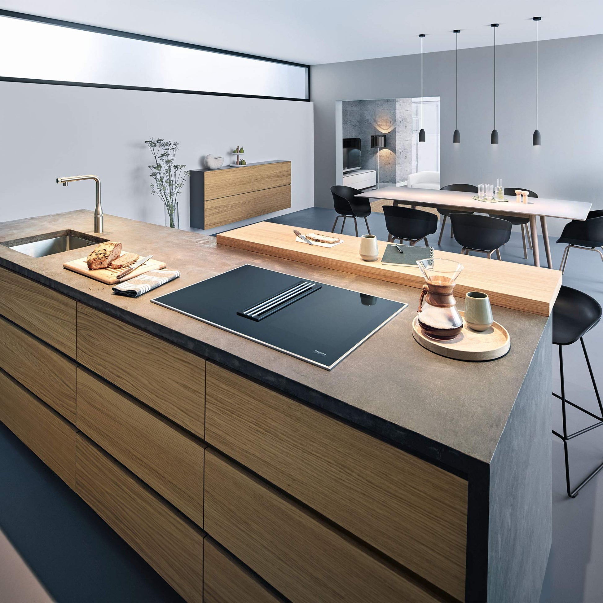 Grohe Essence pull-out kitchen faucet in Supersteel finish installed at kitchen sink with single spray head.