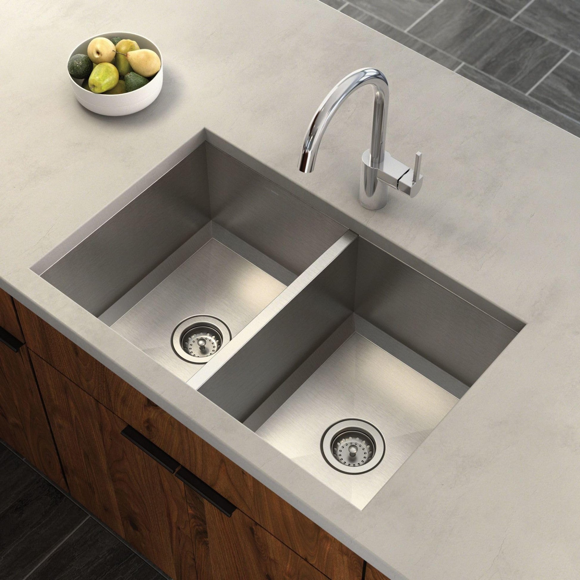 Stainless steel double bowl undermount kitchen sink with two drain baskets and chrome faucet on light countertop.