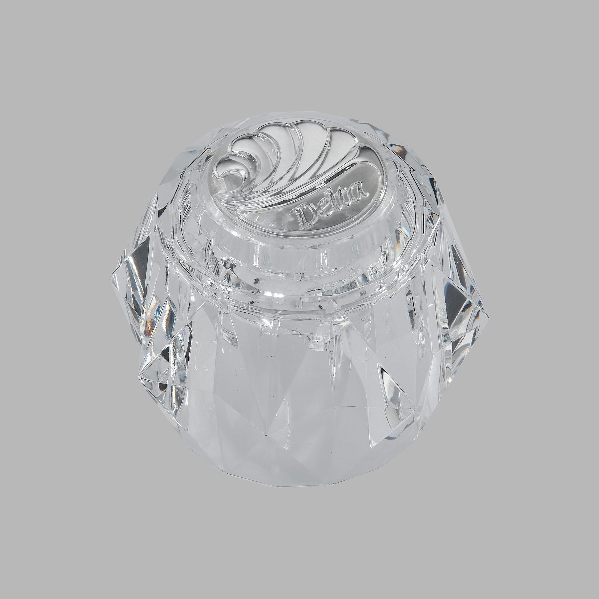 Clear acrylic knob handle with spiral ridge pattern and Delta branding on top.