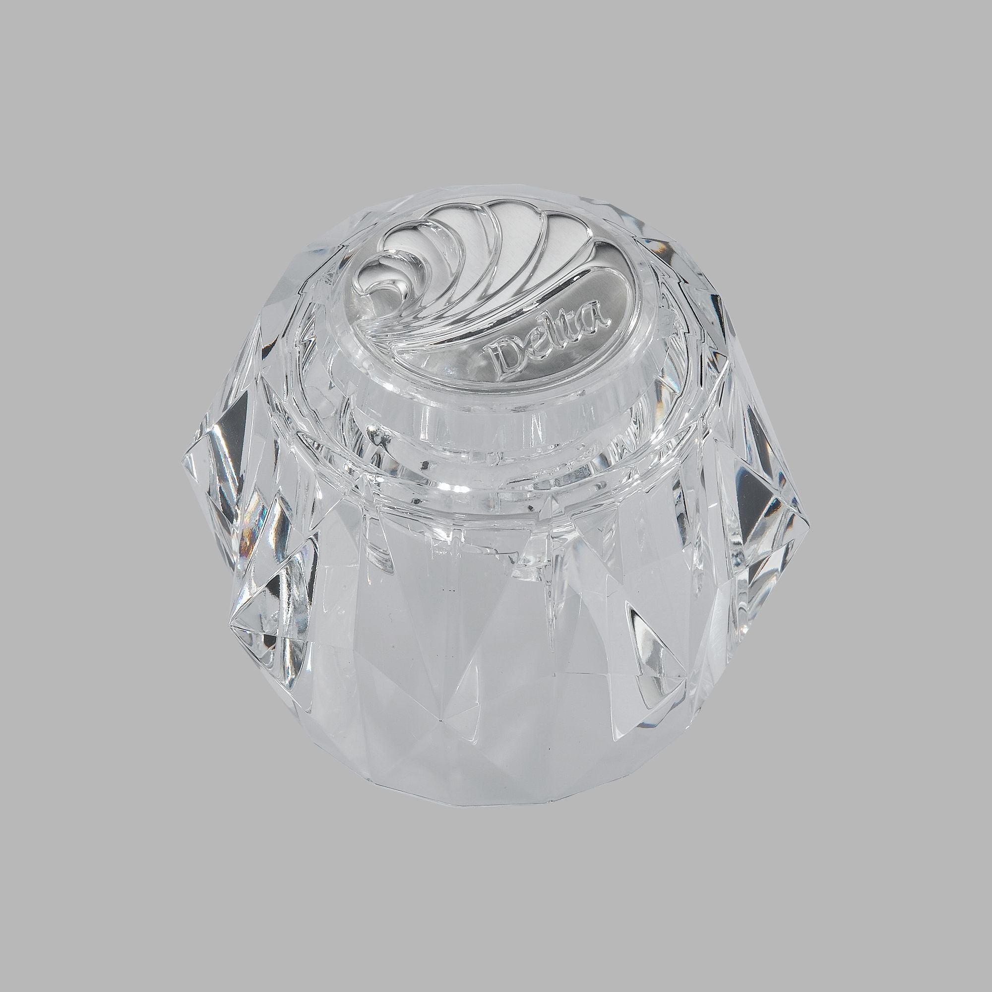 Clear acrylic knob handle with spiral ridge pattern and Delta branding on top.