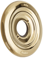 Polished brass circular escutcheon with concentric rings and center opening, Delta and Monitor branding visible.