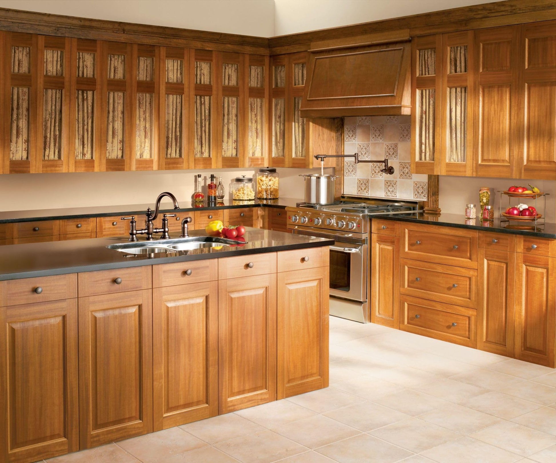 Oil rubbed bronze wall-mounted swing arm pot filler faucet above kitchen island sink with wooden cabinetry.