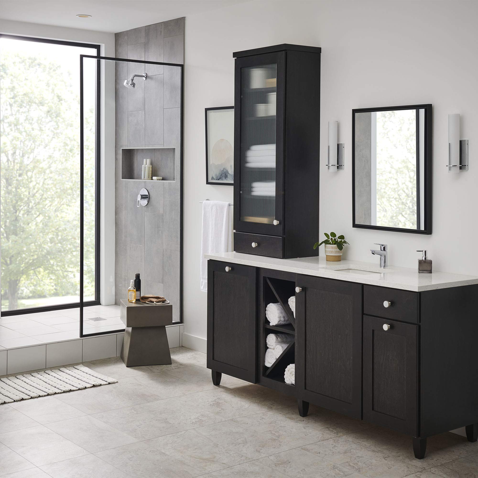 Chrome single-hole bathroom faucet with single handle on white vanity counter in modern bathroom setting.