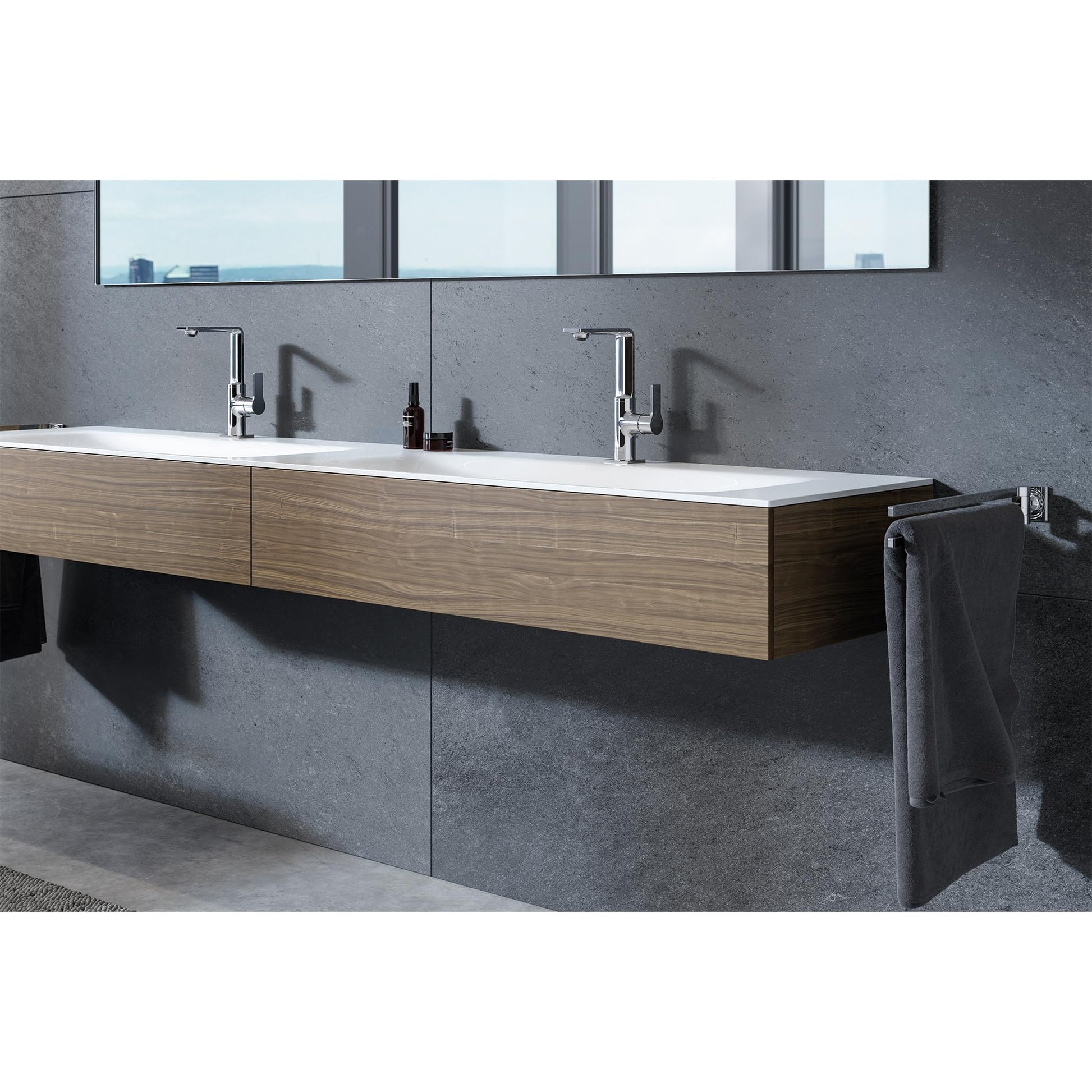 Chrome single-handle bathroom faucet with curved spout installed on floating wooden vanity in modern bathroom.