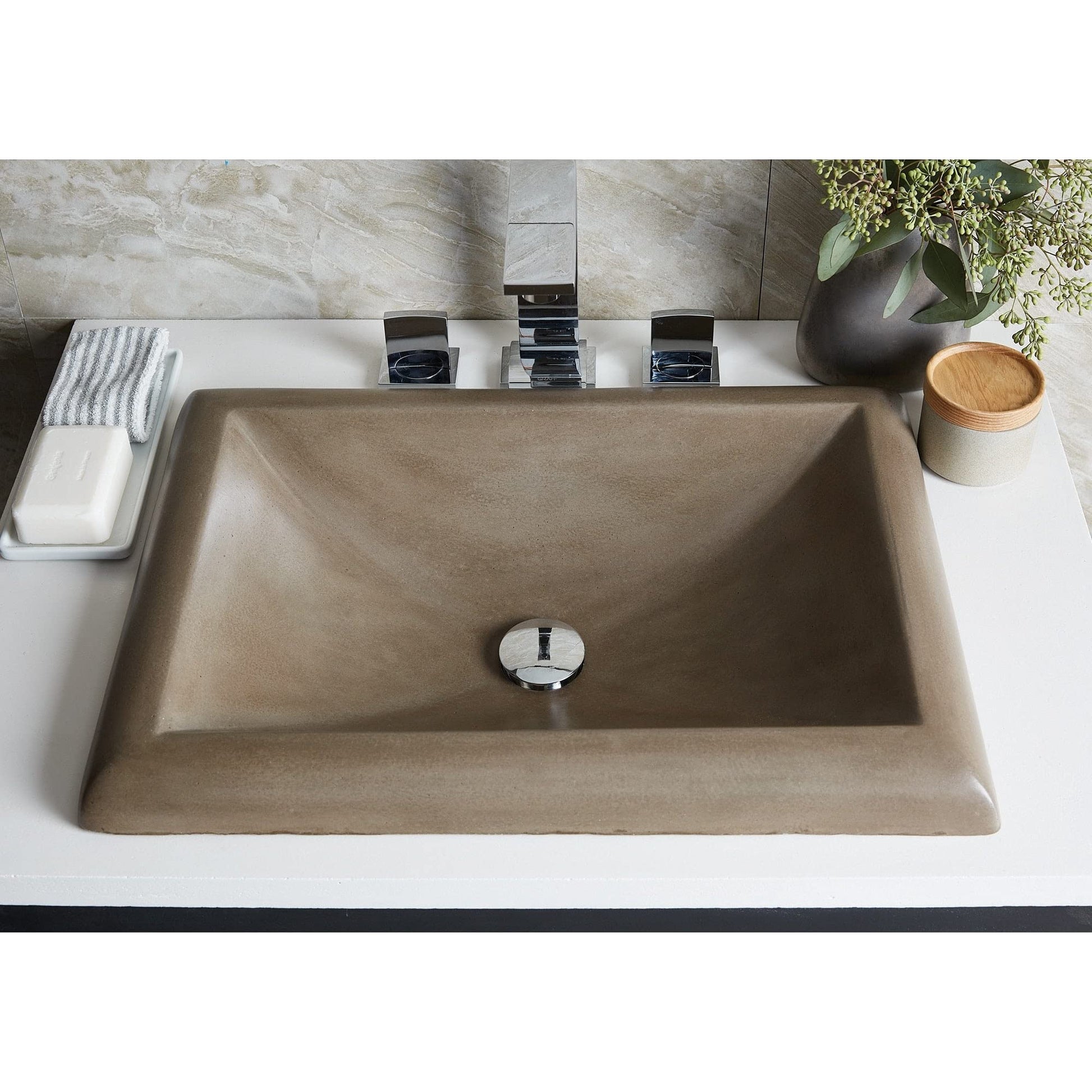 Ash-colored rectangular bathroom sink with sloped sides and single drain hole, installed on white countertop with chrome fauc