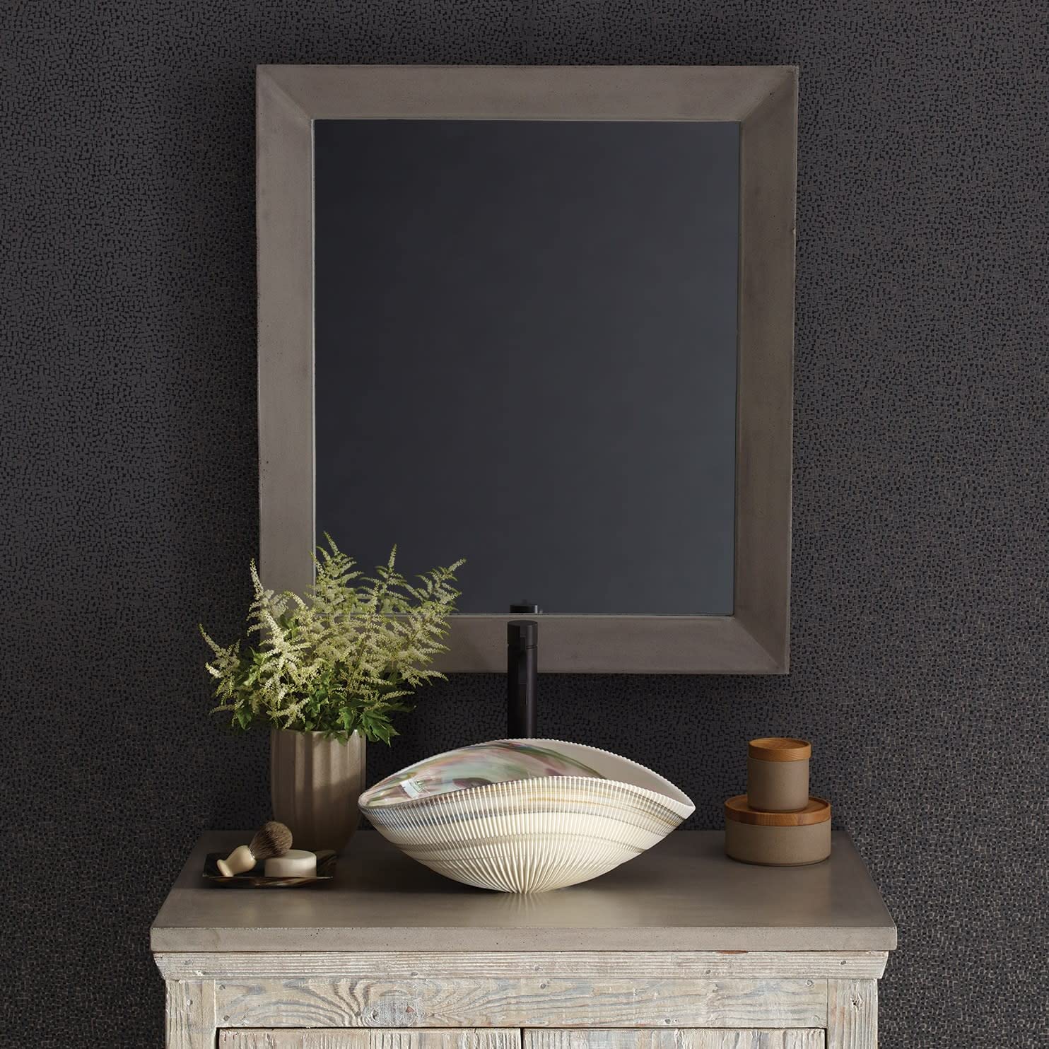 Large rectangular mirror with pearl-colored frame mounted above vanity with fern plant and decorative accessories.