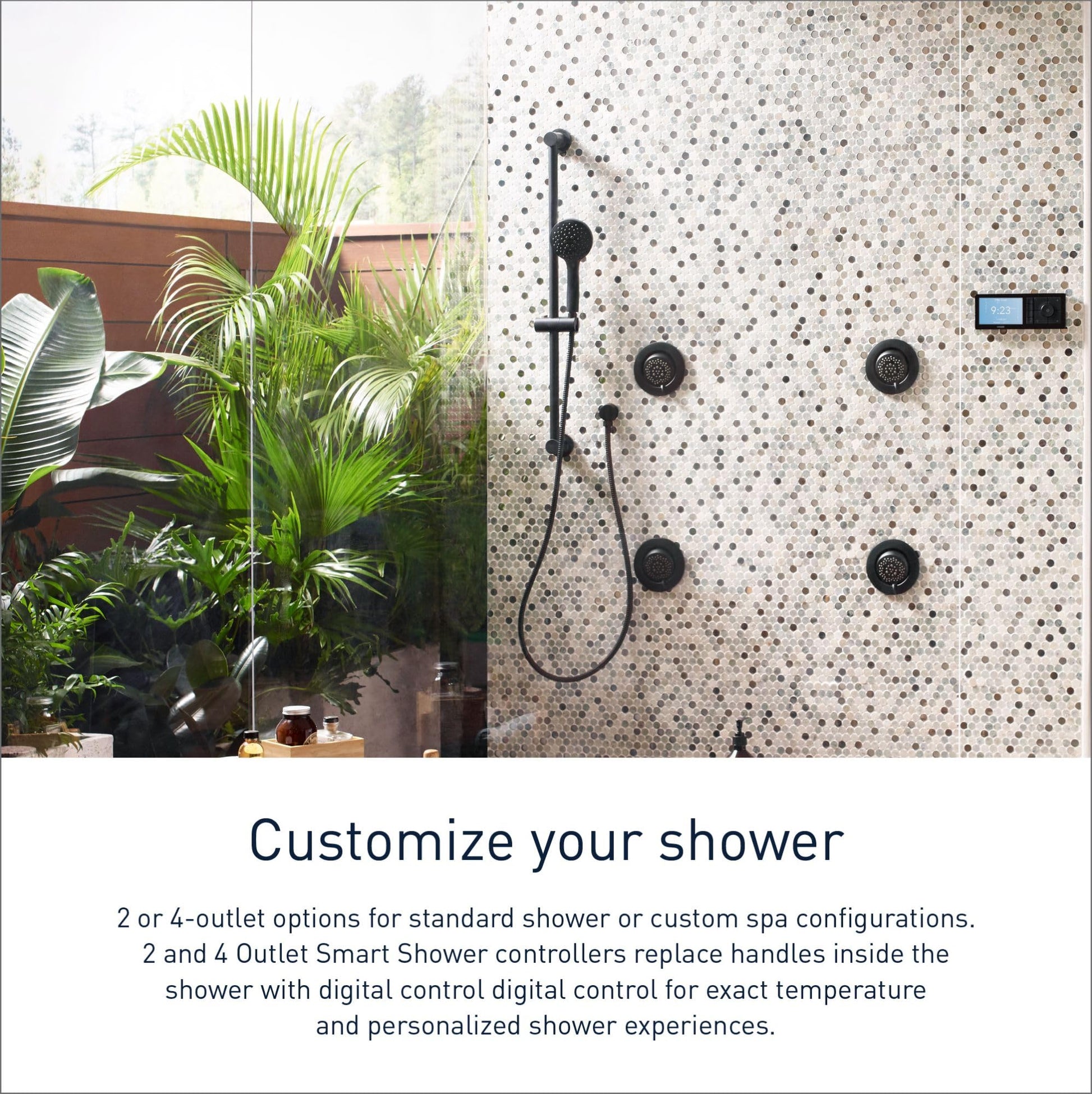 Matte black digital shower controller mounted on speckled tile wall with handheld showerhead and multiple body jets.