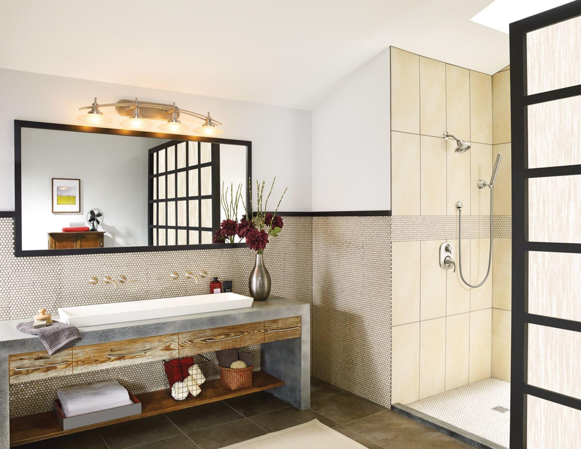 Brushed nickel showerhead mounted on shower wall with single spray function and round faceplate.