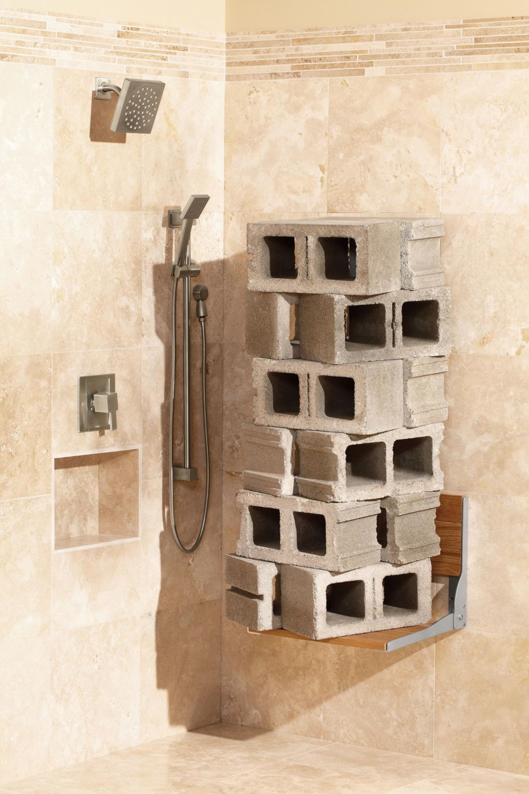 Brushed nickel handheld showerhead with slide bar and metal hose mounted on bathroom tile wall.