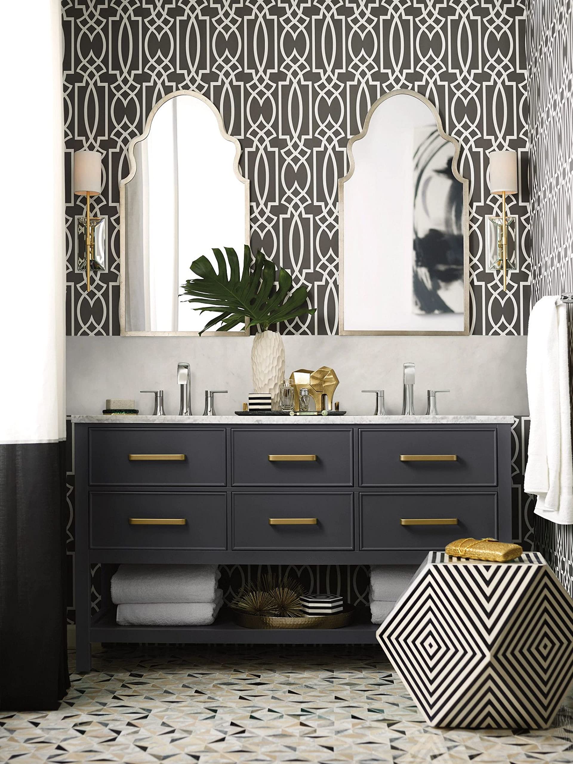 Chrome two-handle widespread bathroom faucet trim with lever handles mounted on white vanity countertop.