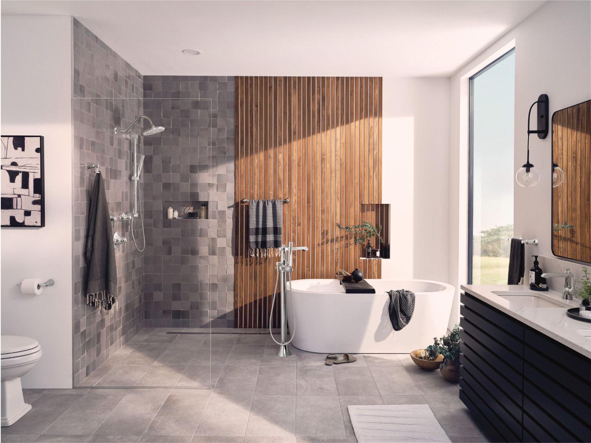 Chrome shower valve trim kit with volume control handle mounted on gray tile wall in modern bathroom.
