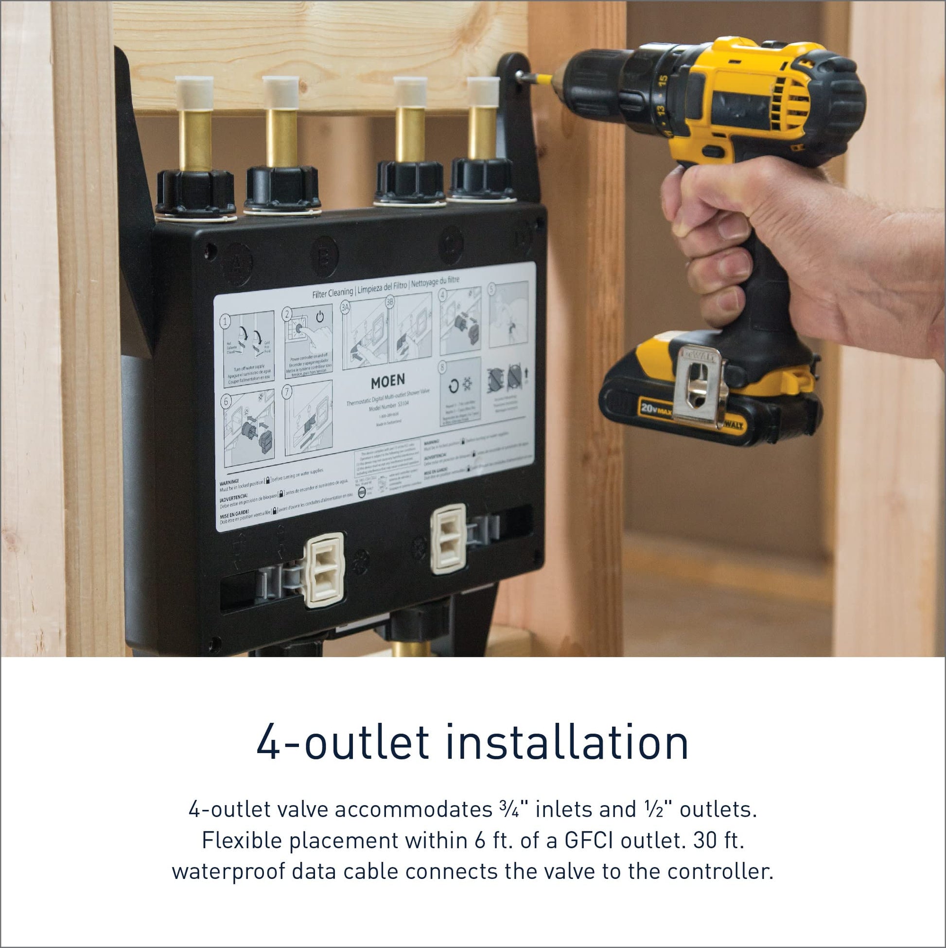 Moen S3104 digital valve with four brass outlets mounted in wall cavity during installation with drill.